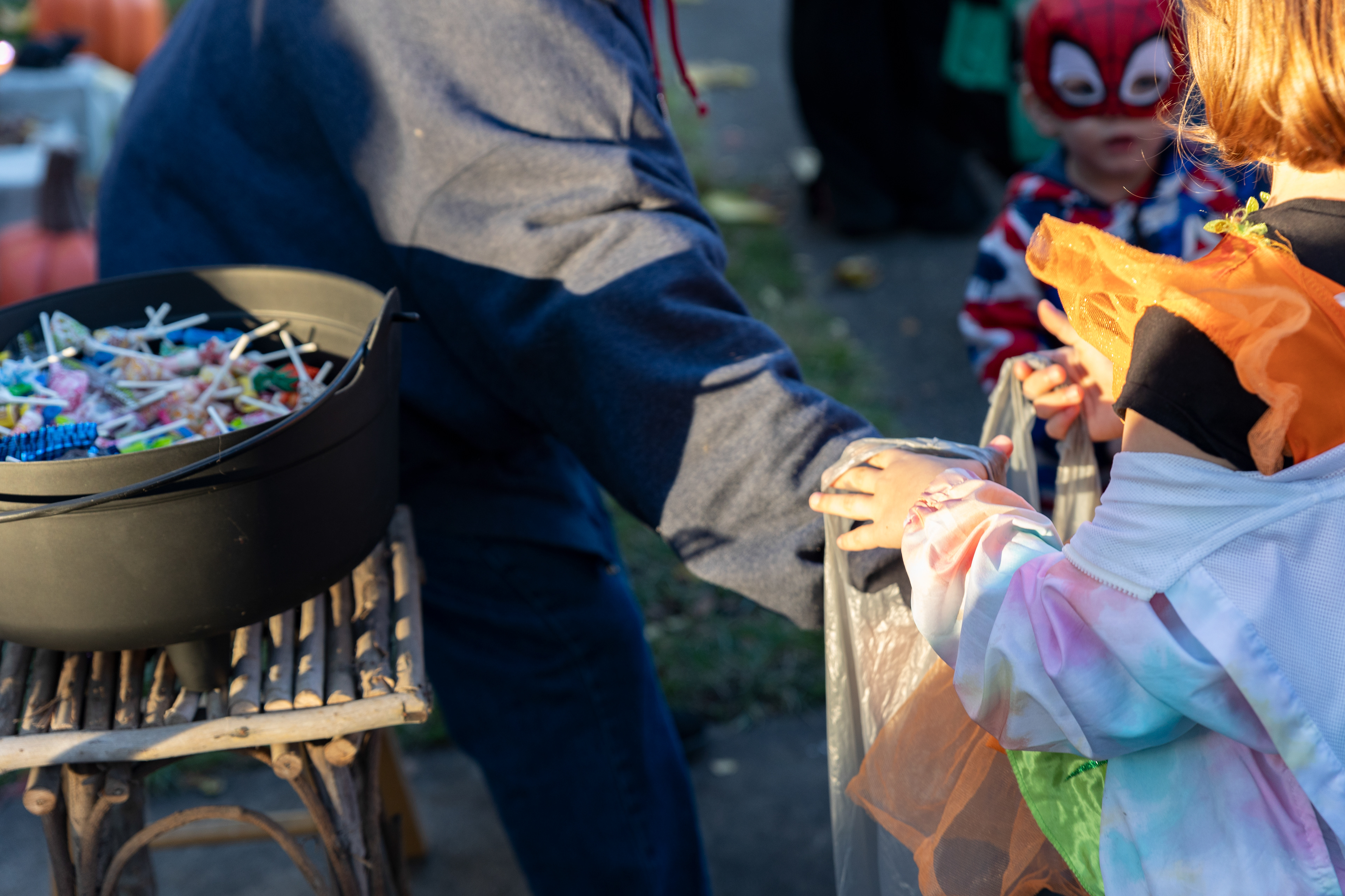 Kinda Brown passes out candy to trick-or-treaters Oct. 31, 2023. Many children in Wellston use plastic bags from stores such as Walmart and Doller General to hold their candy instead of Halloween baskets or bags.