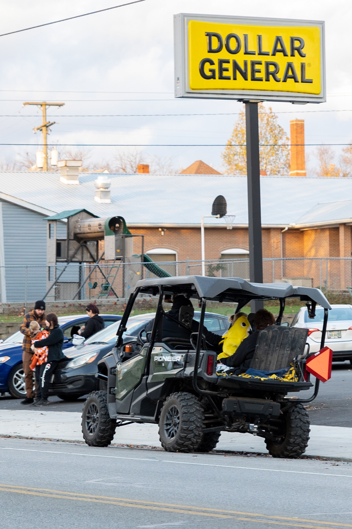 A UTV parks alongside Pennsylvania Avenue in front of a Dollar General in Wellston, Ohio, Oct. 30, 2023. UTVs are a common sight on Halloween in Wellston, as parents use these vehicles to transport their children more quickly and easily.