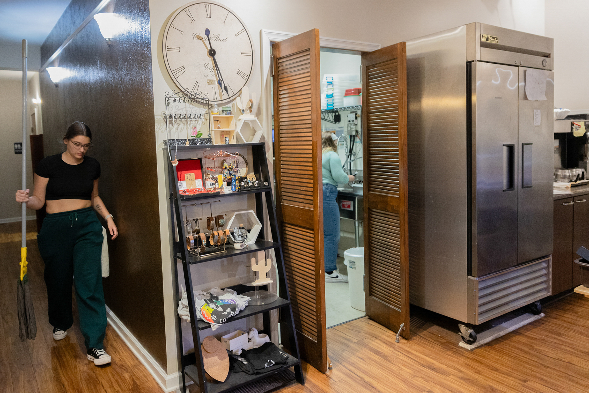 Olivia Snyder (left) and Karley Ackert (right) begin to clean the shop so that they can close for the day. Ackert, who has been working there for two years, oversees the dishes and counts the money in the register. Snyder oversees sweeping and mopping the floors. Sometimes a customer will walk in just before closing while they are cleaning, and they will have to restart their cleaning process.