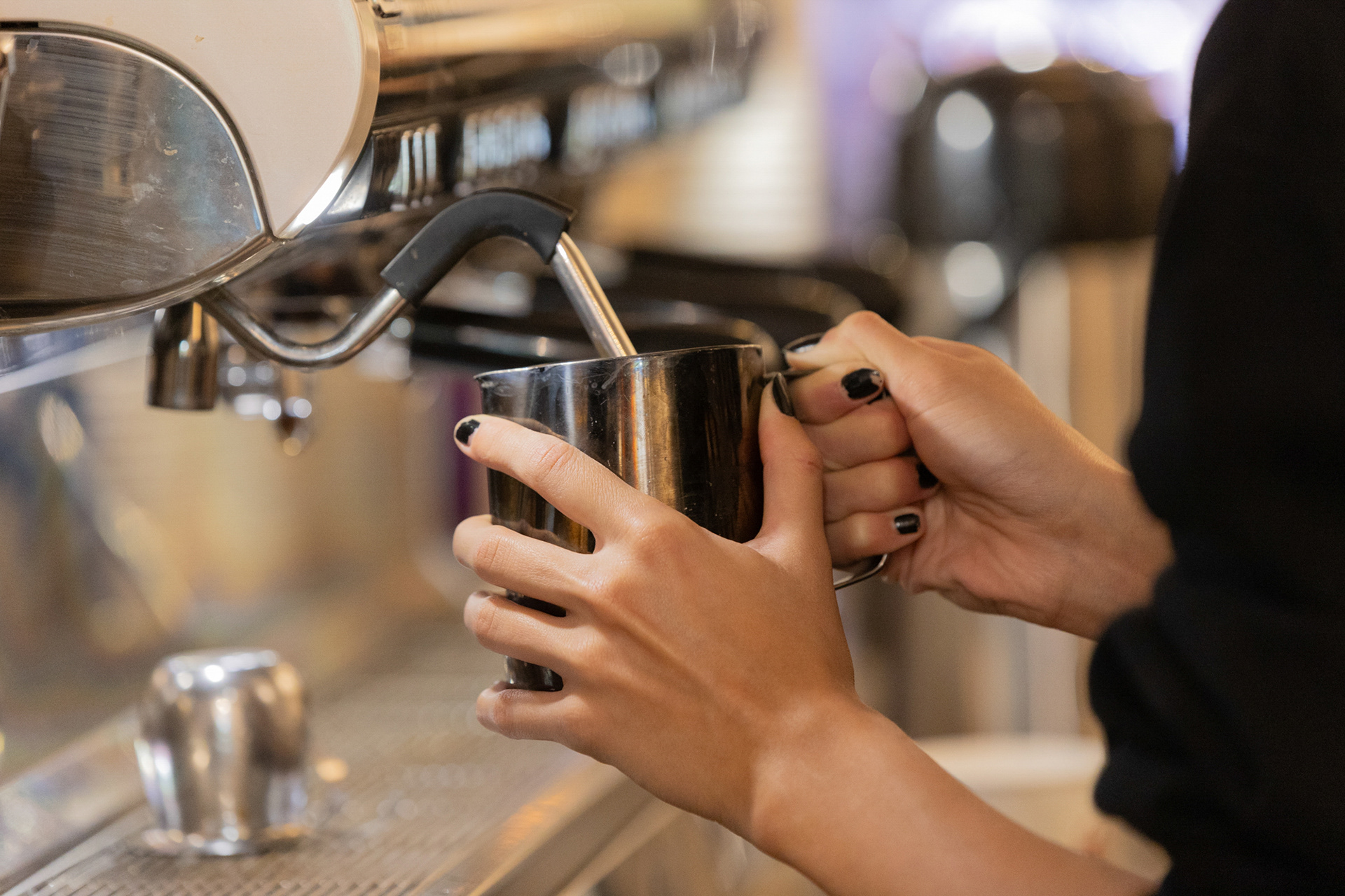 Isabele Hamm steams milk in a cup to make a hot espresso drink for a customer. Espressos are made of very finely ground coffee, usually seven to nine grams, tamped down so that the water flows over the grounds evenly. Once you have the coffee, milk is steamed until you have the desired amount of foam and poured over the coffee.