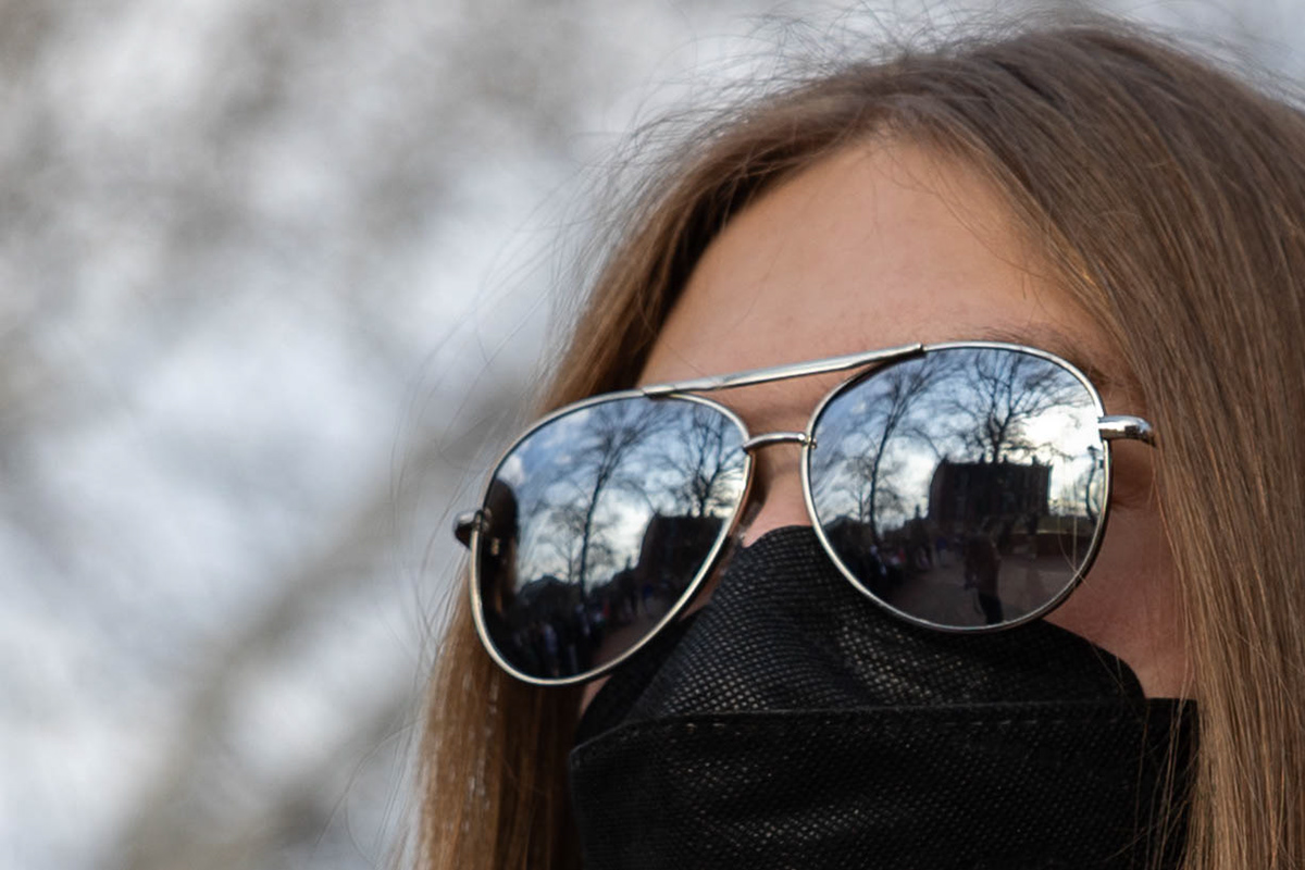 Cutler Hall shows in the reflection from a protestor's sunglasses during the Athens Justice Coalition's Divest from Death campaign outside Cutler Hall, Ohio University, Feb. 26, 2025. The protestor preferred to remain anonymous.