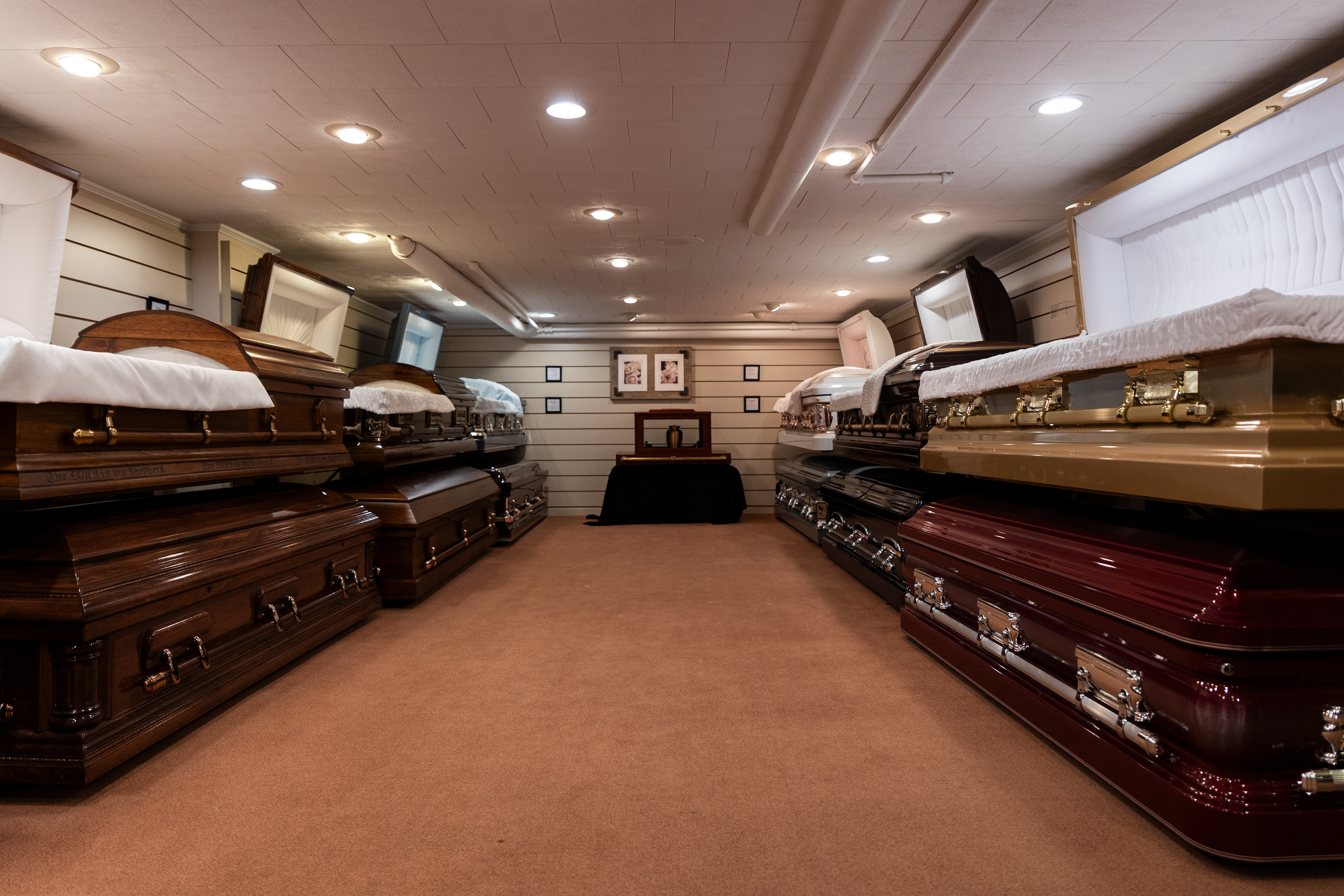 One side of the show room in Hillis and Combs Funeral Home is caskets made from various woods like pine, cherry or oak and on the other side are made from metals like bronze.