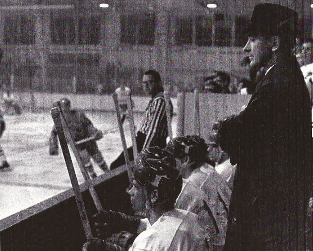 Coach John McComb and Bobcat players watch the game from the bench, Bird Ice Arena, Athens, Ohio (Photo Courtesy: Ohio University Archives)