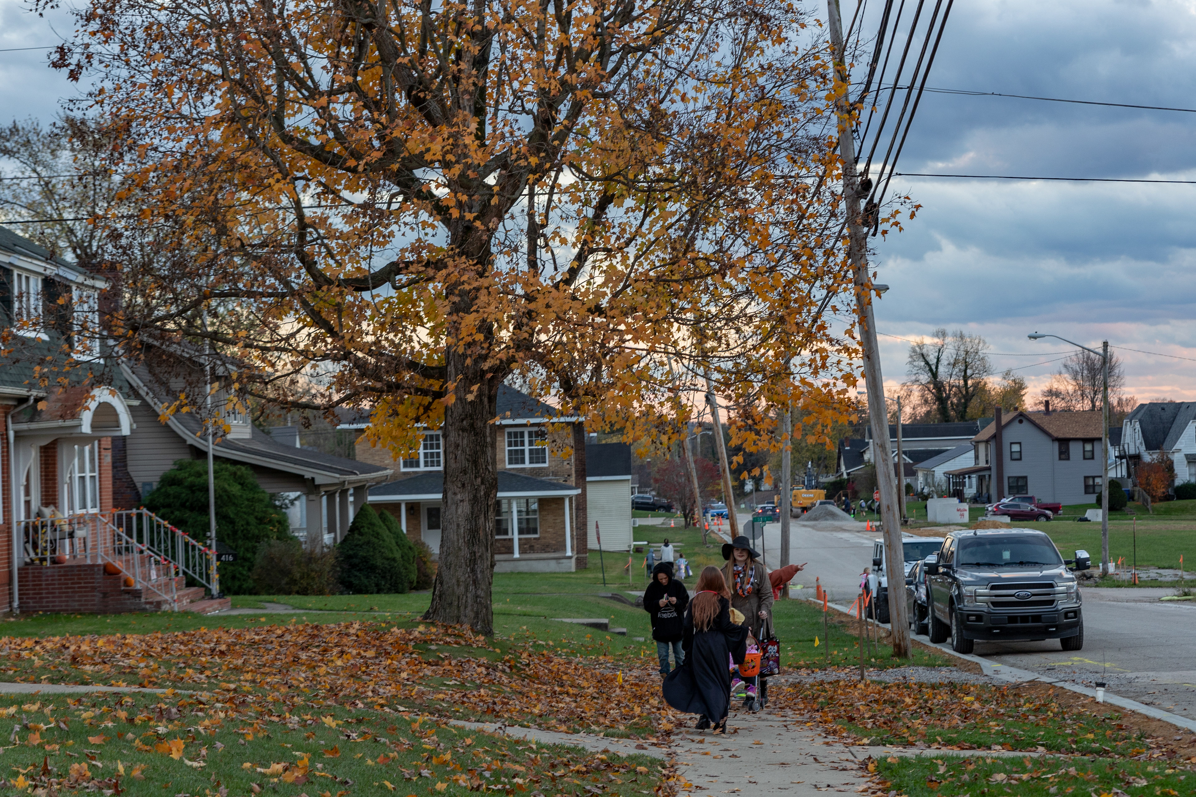 Trick-or-treaters walk South New York Avenue in Wellston, Ohio, Oct. 31, 2023.