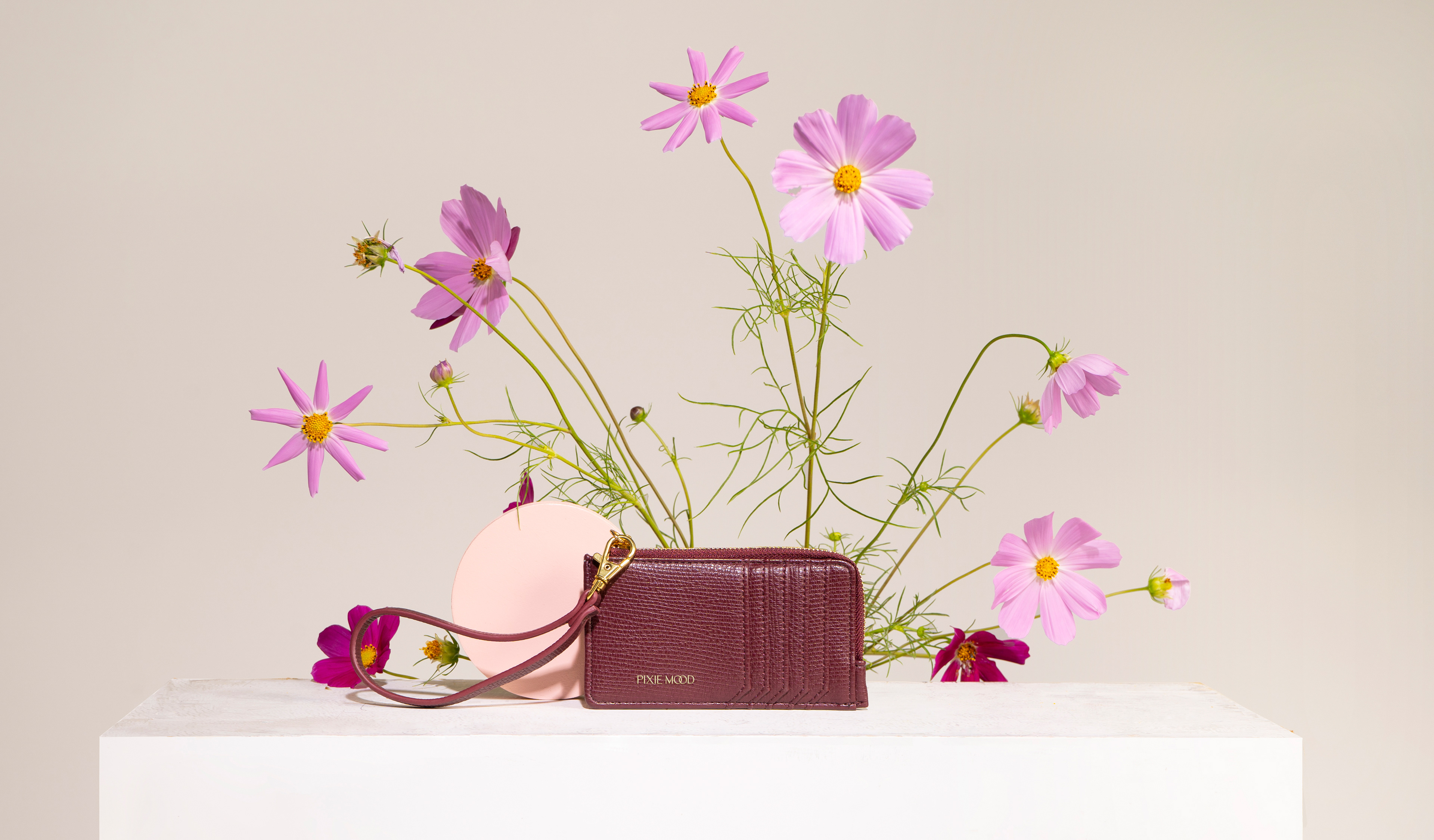Photo of a Pixie Mood wallet with florals in the background.