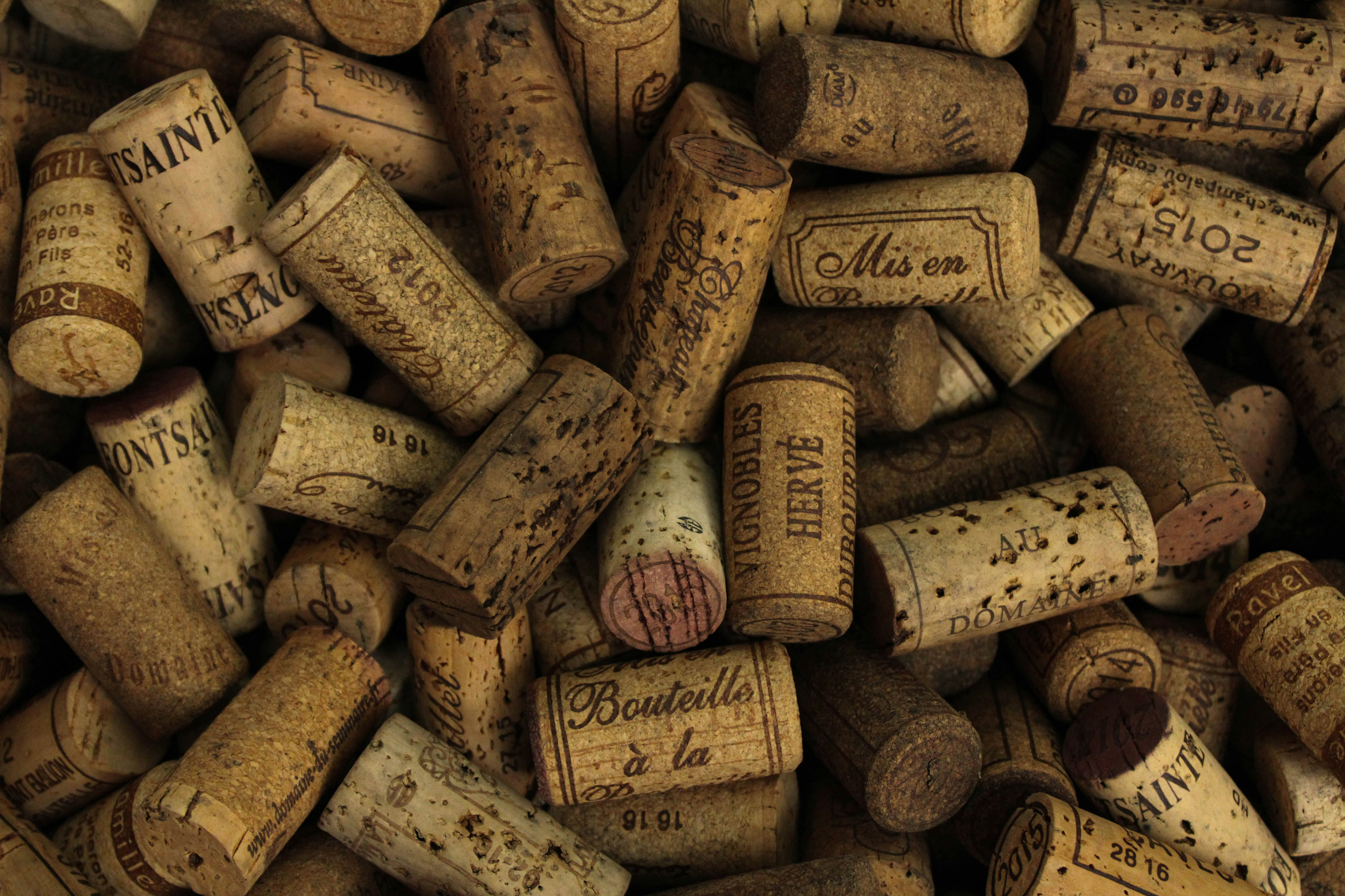 Several wine corks in a pile of wines of very old and well-known vintages / The Gastro Label / www.gastro-label.com