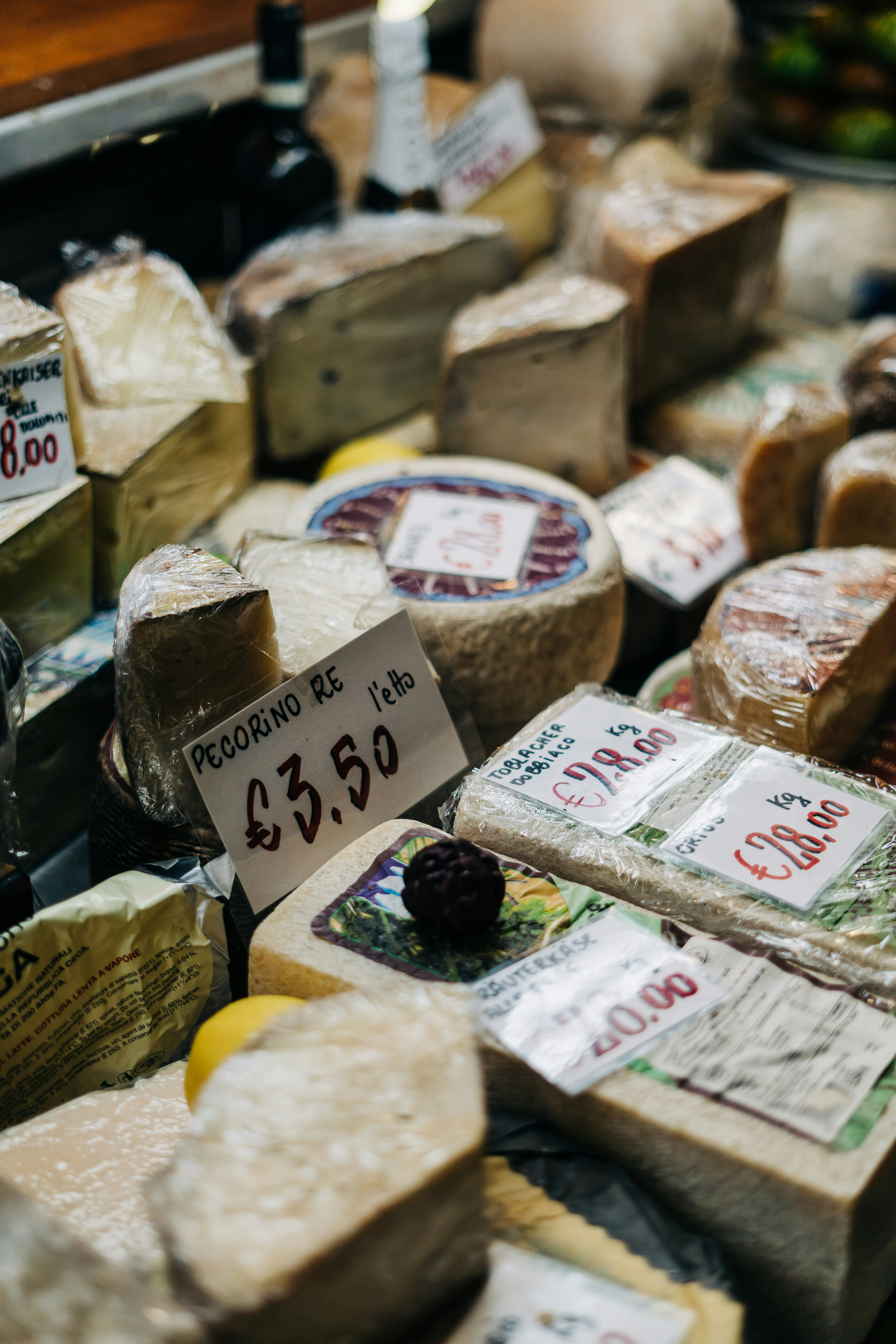 Various types of cheese laid out in a display case ready for sale/ The Gastro Label / www.gastro-label.com