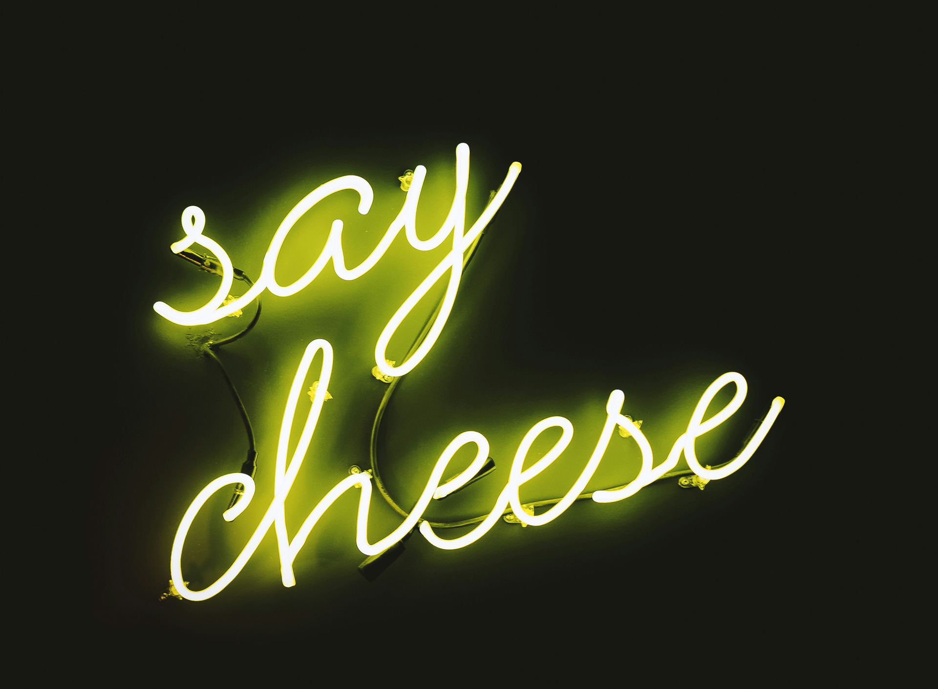A neon sign with the text “Say Cheese” in yellow.