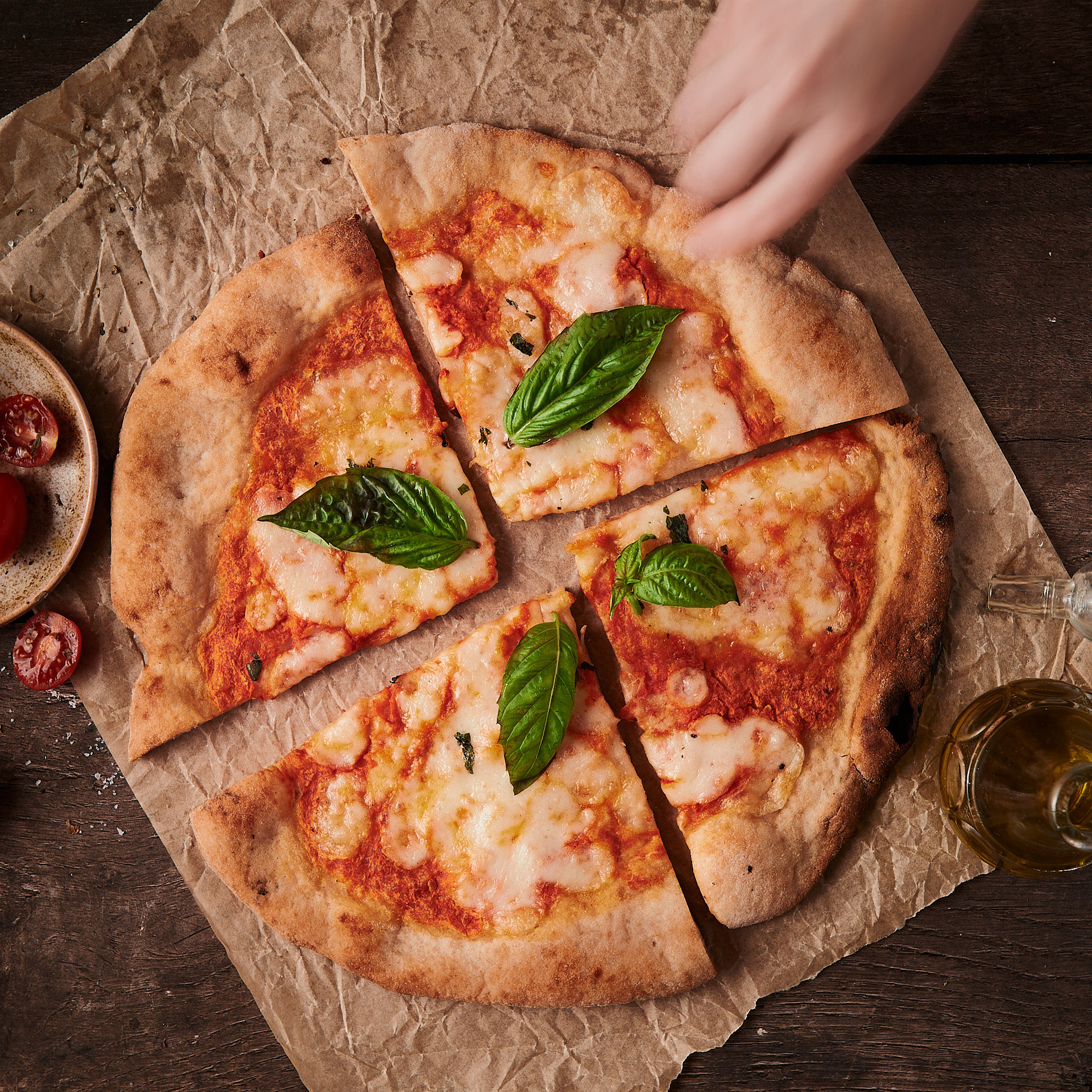 Lifestyle photography of fresh pizza, showcasing texture and social dining atmosphere by Montreal food photographer Kata Endrodi.