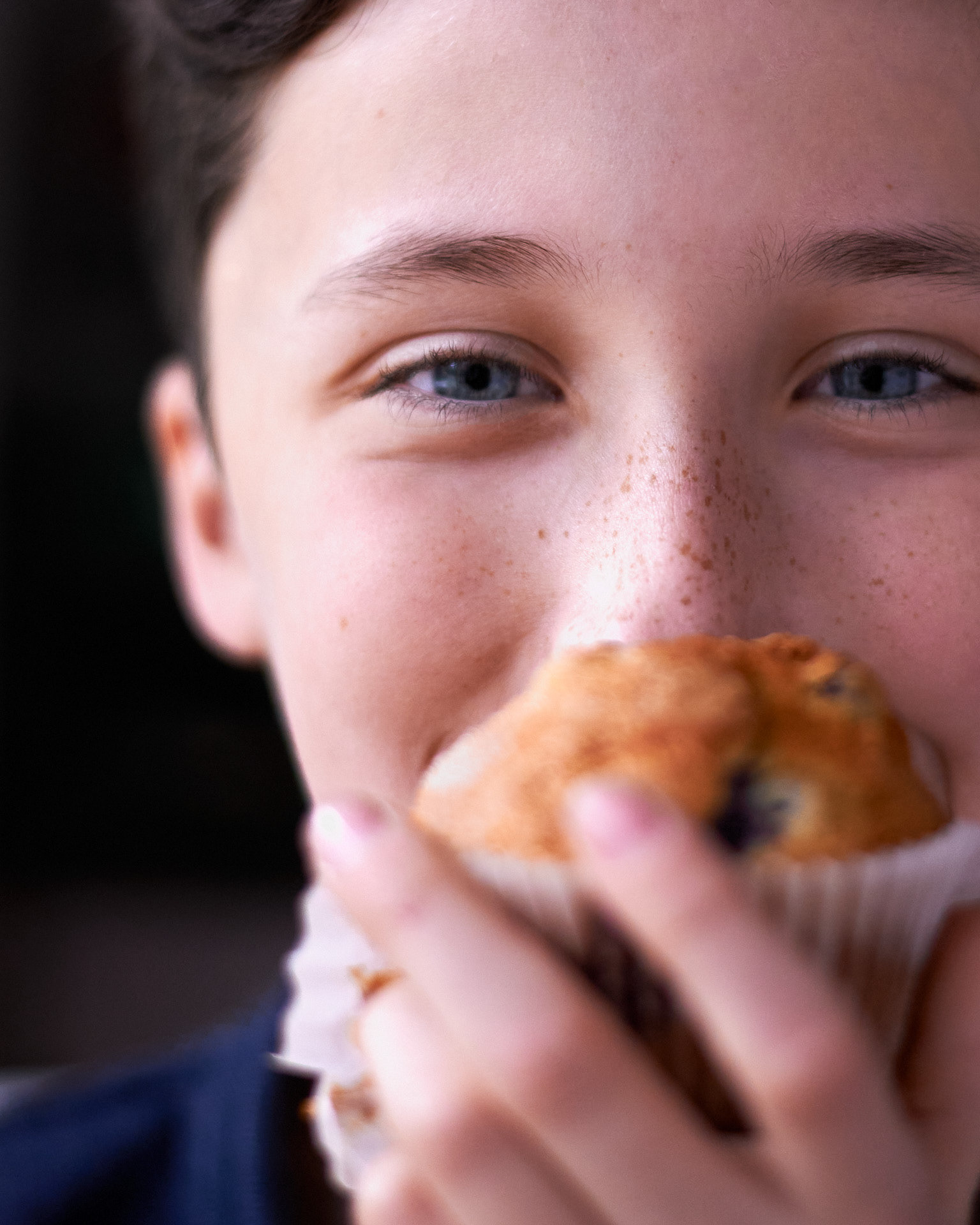 A food photography boy holding a muffin close up image, made by Kata Endrodi, a food photographer in Montreal