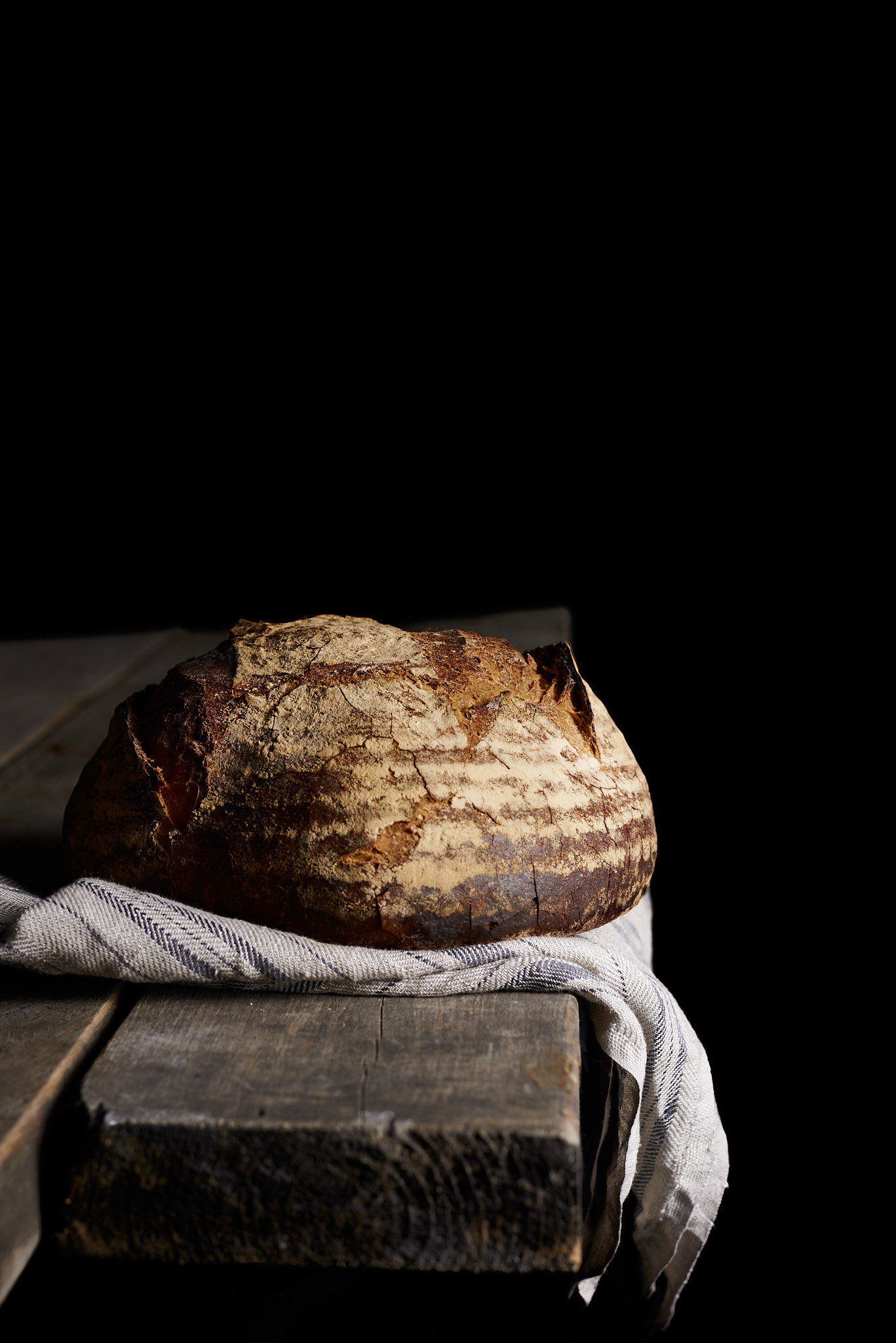 A food photography loaf of bread on tea towel image, made by Kata Endrodi, a food photographer in Montreal