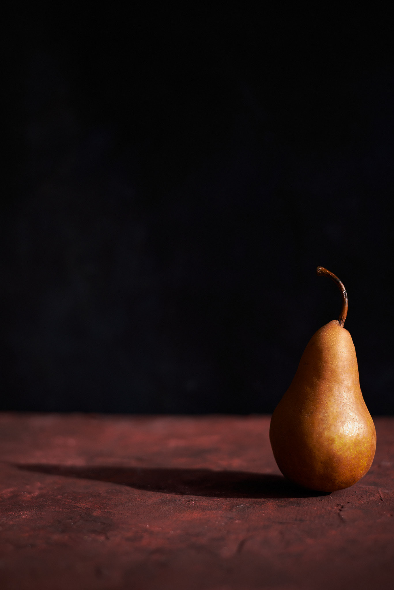A food photography pear and its shadow image, made by Kata Endrodi, a food photographer in Montreal