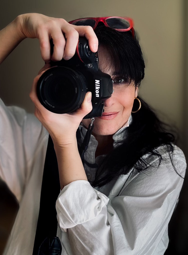 A self portrait photography image with camera in hands, made by Kata Endrodi, a food photographer in Montreal