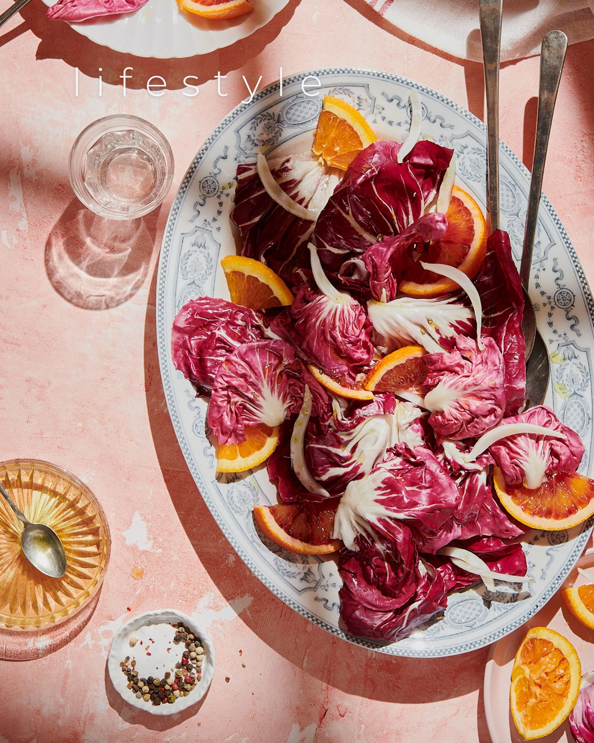 Kata Endrodi Montreal food and product photographer: A high-end lifestyle counter scene featuring colorful orange fennel radicchio salad arrangement on a summer table with hard light.
