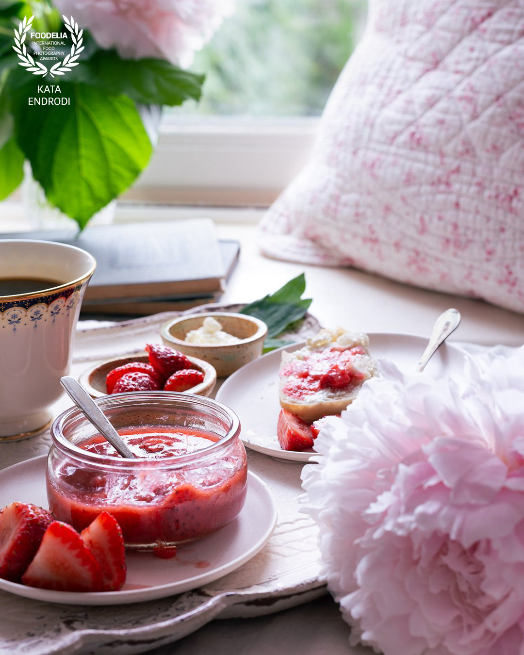 A food photography breakfast brunch image with strawberries, jam, coffee and flowers, made by Kata Endrodi, a food photographer in Montreal