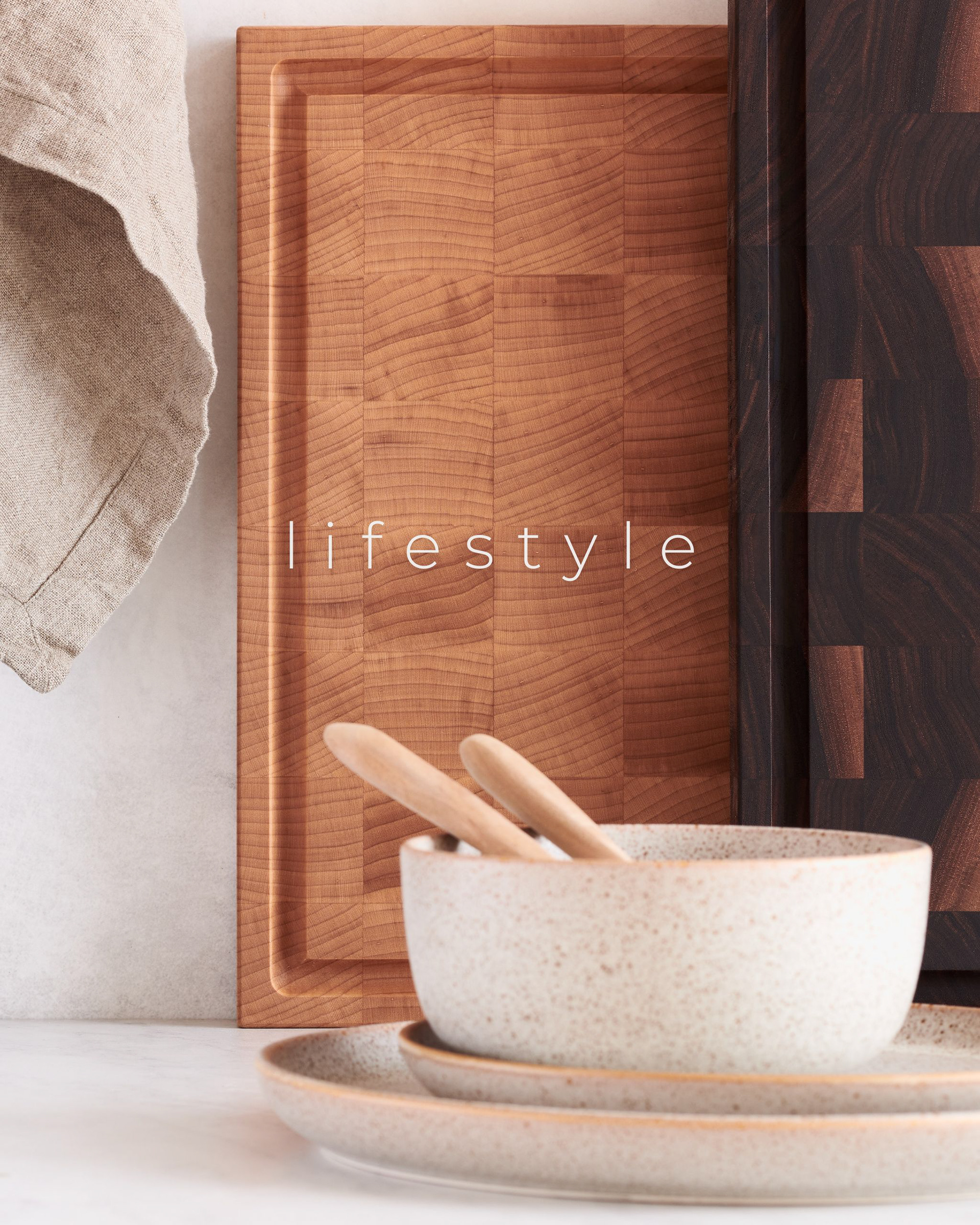 Kata Endrodi Montreal food and product photographer, a minimalist kitchen counter scene featuring wooden cutting boards, a coffee machine, and stoneware.