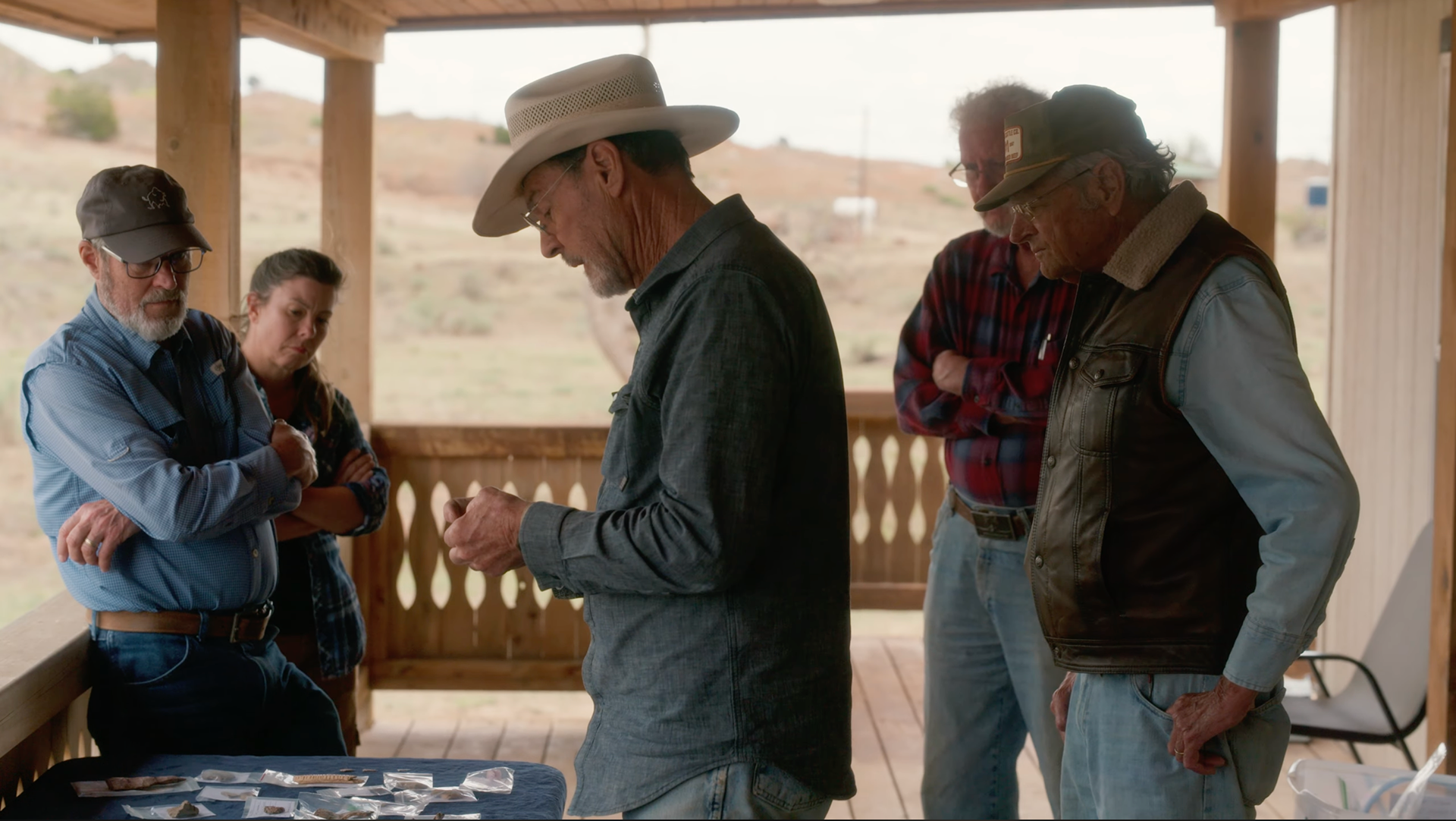 Doug Wilkens shows an artifact to John Erickson, Joe Rogers, Tiffany Osburn and Doug Boyd in a brand documentary for PAR called West Pasture Archeology.