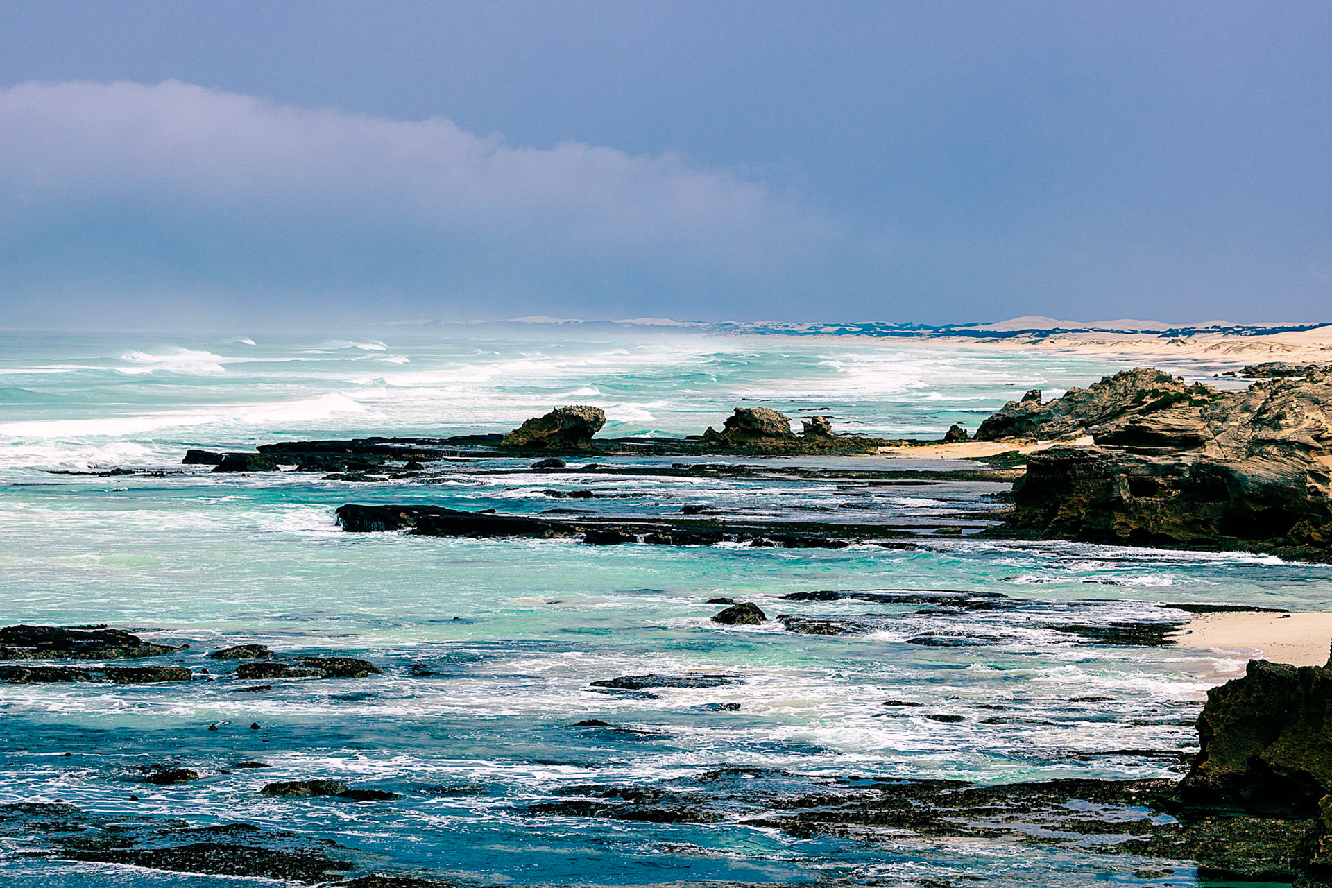 Photograph of the ocean on a cloudy and rainy day.