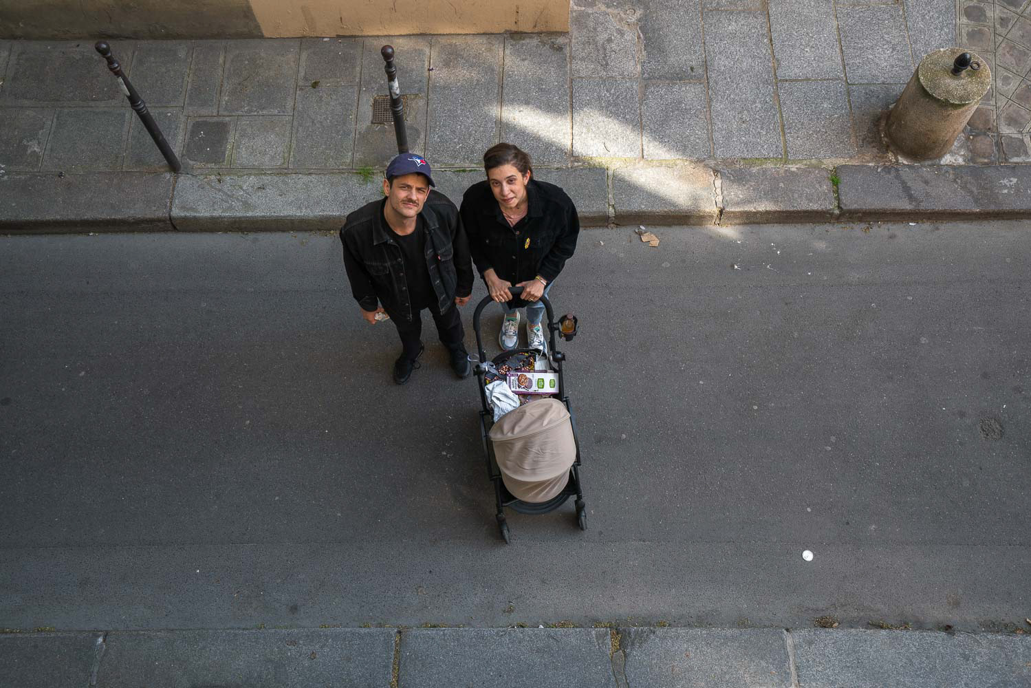 A lovely couple taking their newborn for a stroll in the quiet streets of Paris