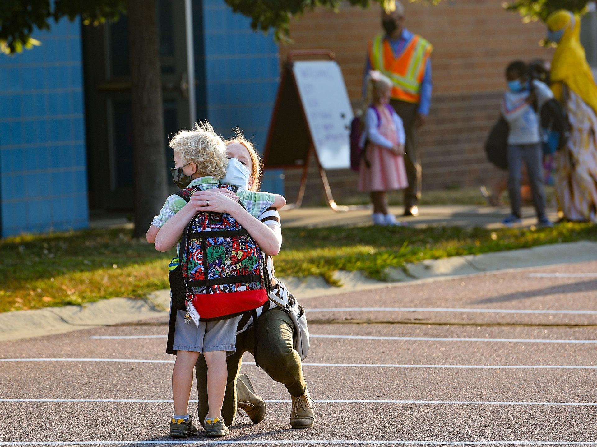Lisa Frock hugs her first-grader, Theodore, before sending him in for the first day of school on Thursday, August 27, 2020 at Discovery Elementary School in Sioux Falls. Visitor restrictions due to the pandemic meant that parents had to say their goodbyes on the playground instead of walking their child into the building.