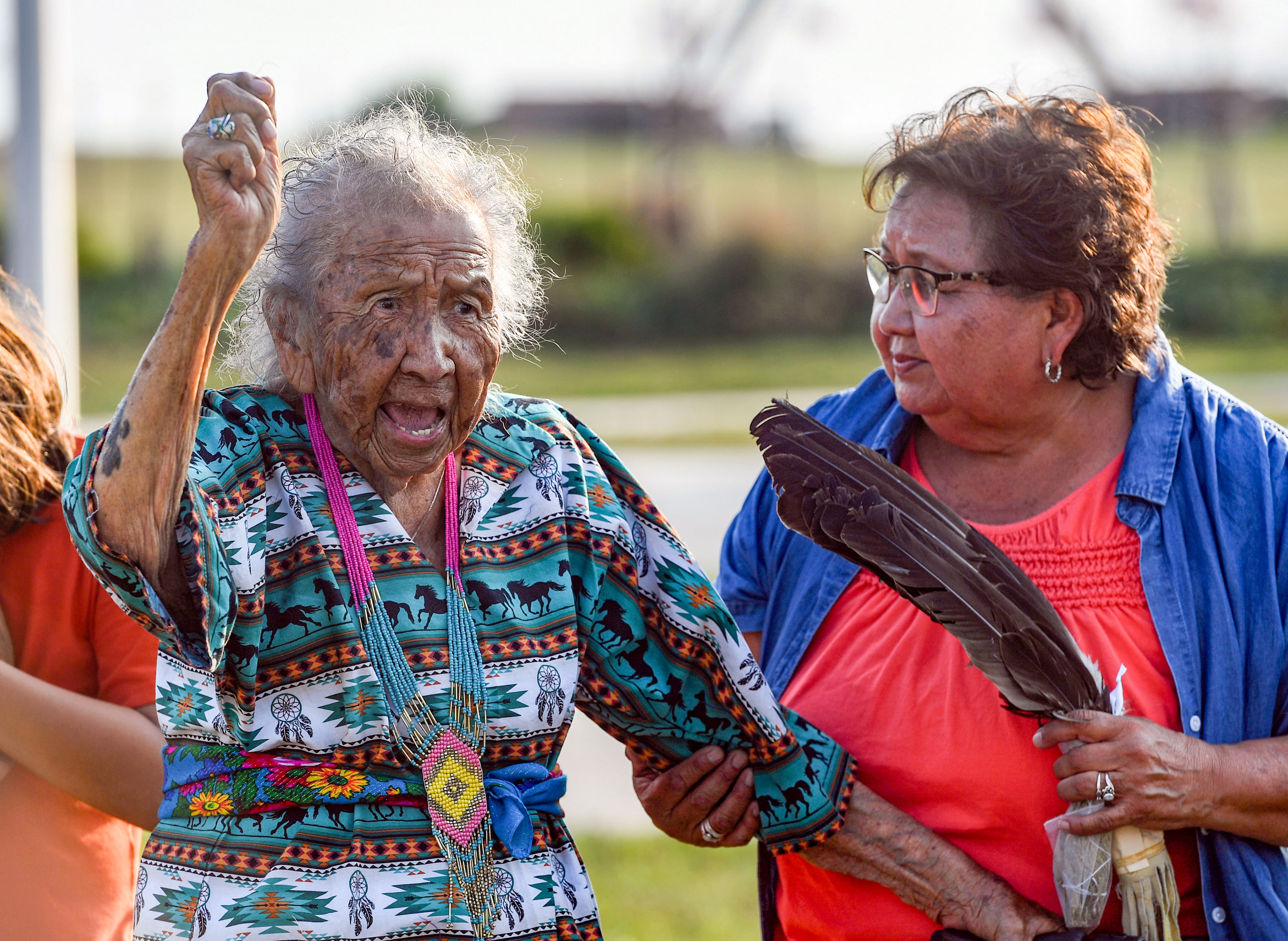 Mary Randall, a 101 year old Rosebud Sioux elder, speaks passionately in Lakota before tossing dirt in each grave of the six children whose remains were returned home after 142 years on Friday, July 17, 2021 at the Rosebud Sioux Tribe Veterans Cemetery.