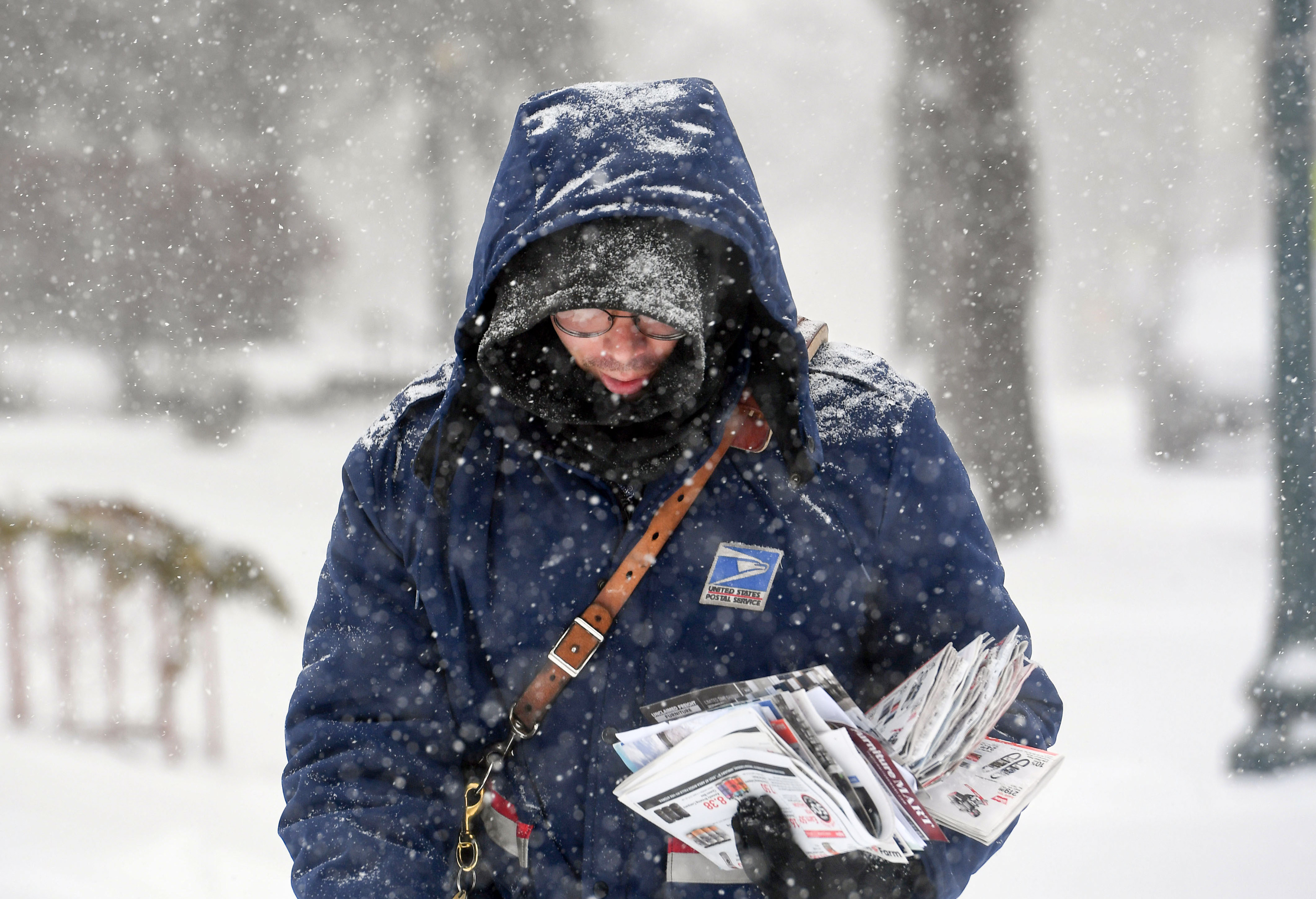 Tommy Heuer delivers mail during a winter storm on Tuesday, December 29, in Sioux Falls.