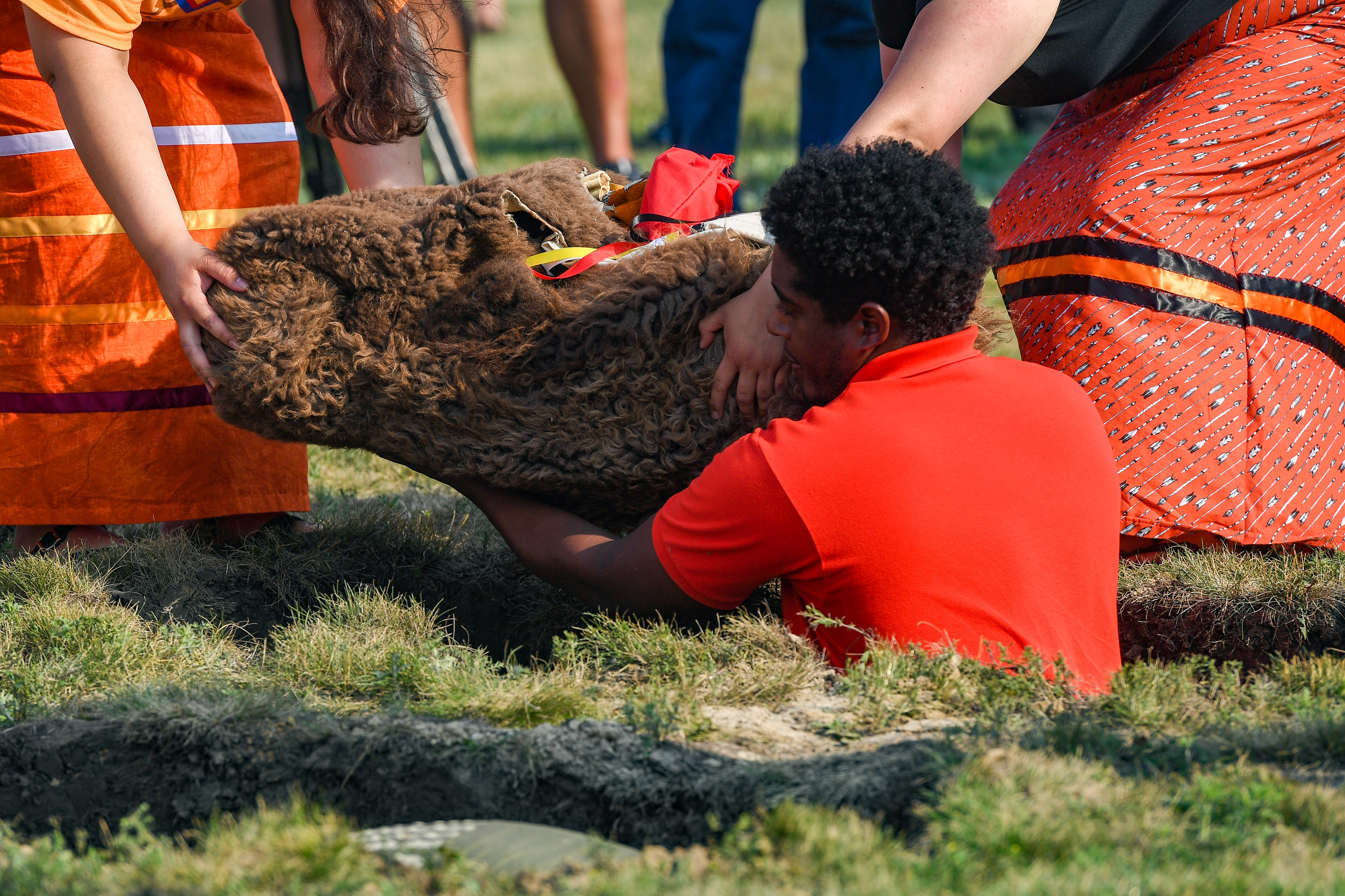 Relatives and tribal members lower the remains of Rosebud Sioux children into their final grave site 142 years after their deaths on Friday, July 17, 2021 at the Rosebud Sioux Tribe Veterans Cemetery.