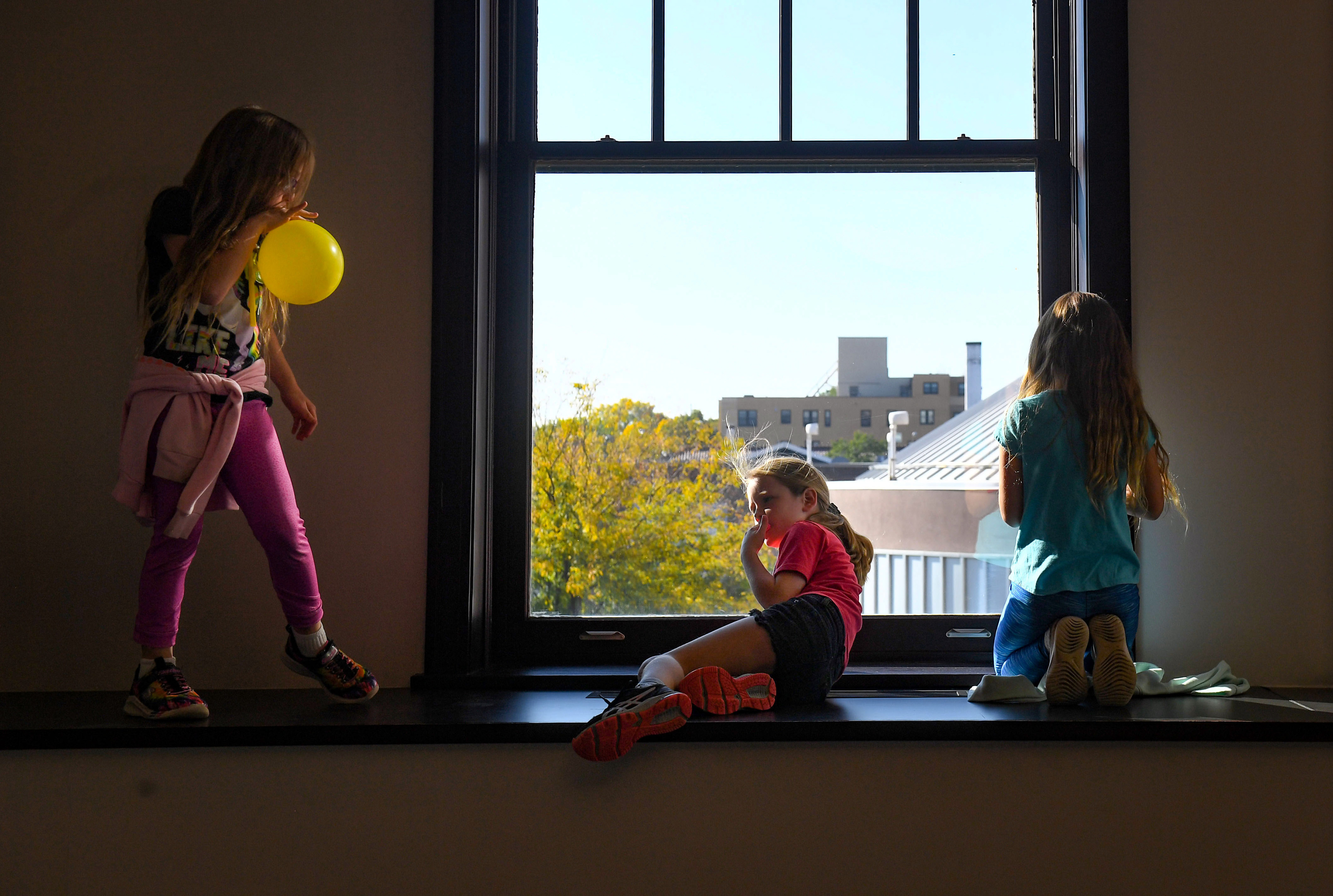 Girls look out the window at downtown during a day camp highlighting STEAM (science, technology, engineering, arts and math) on Tuesday, October 11, 2022, at the Washington Pavilion in Sioux Falls.