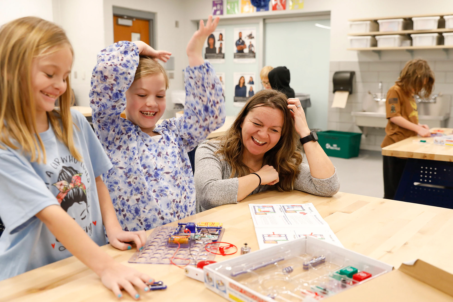 Kelly Grell and Mariah Tetlow celebrate as they complete a circuit board on January 8, 2024, at Mason Elementary.