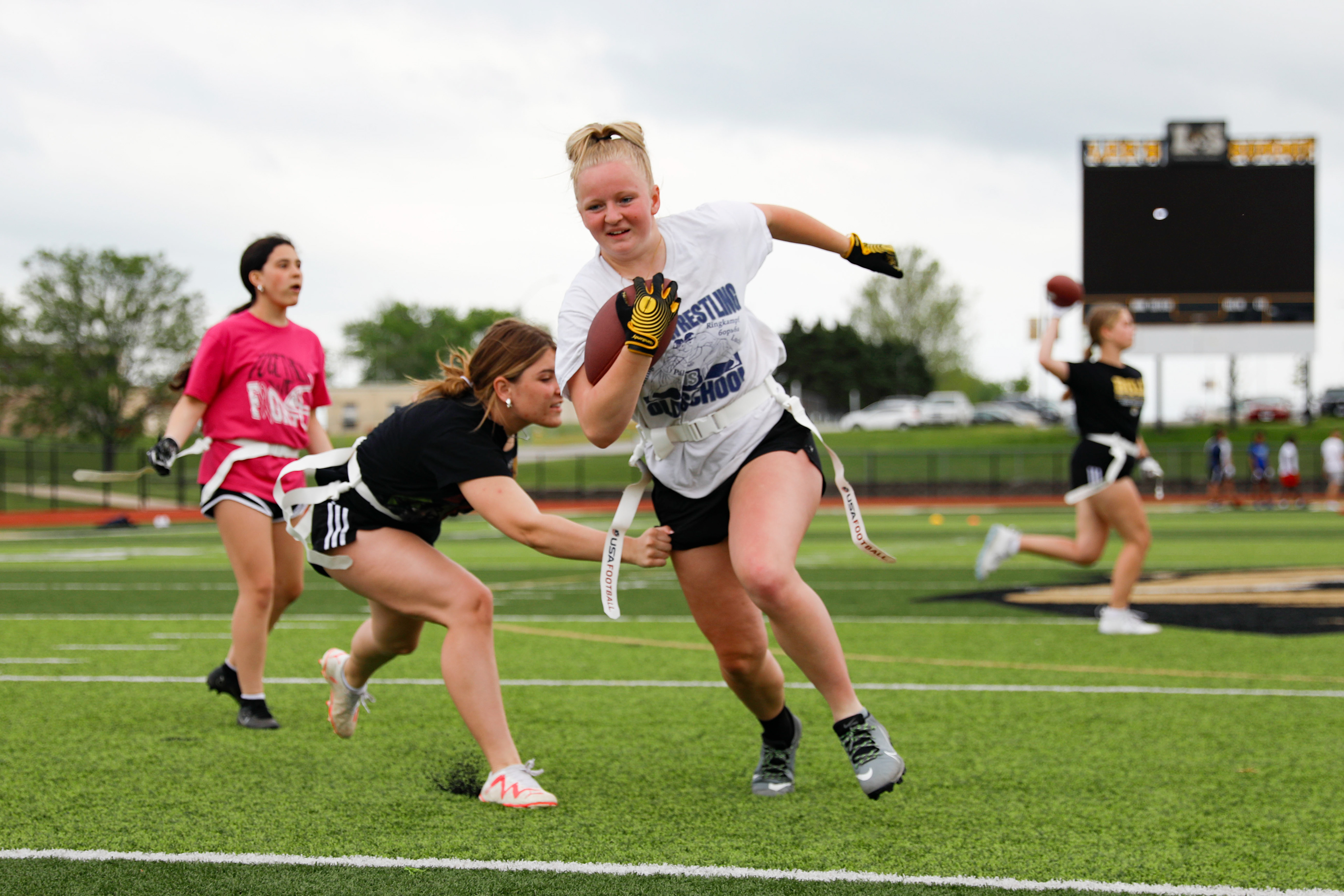 Lee’s Summit High School flag football players run drills during practice on May 6, 2024, as part of the first-ever girls flag football season in the district.