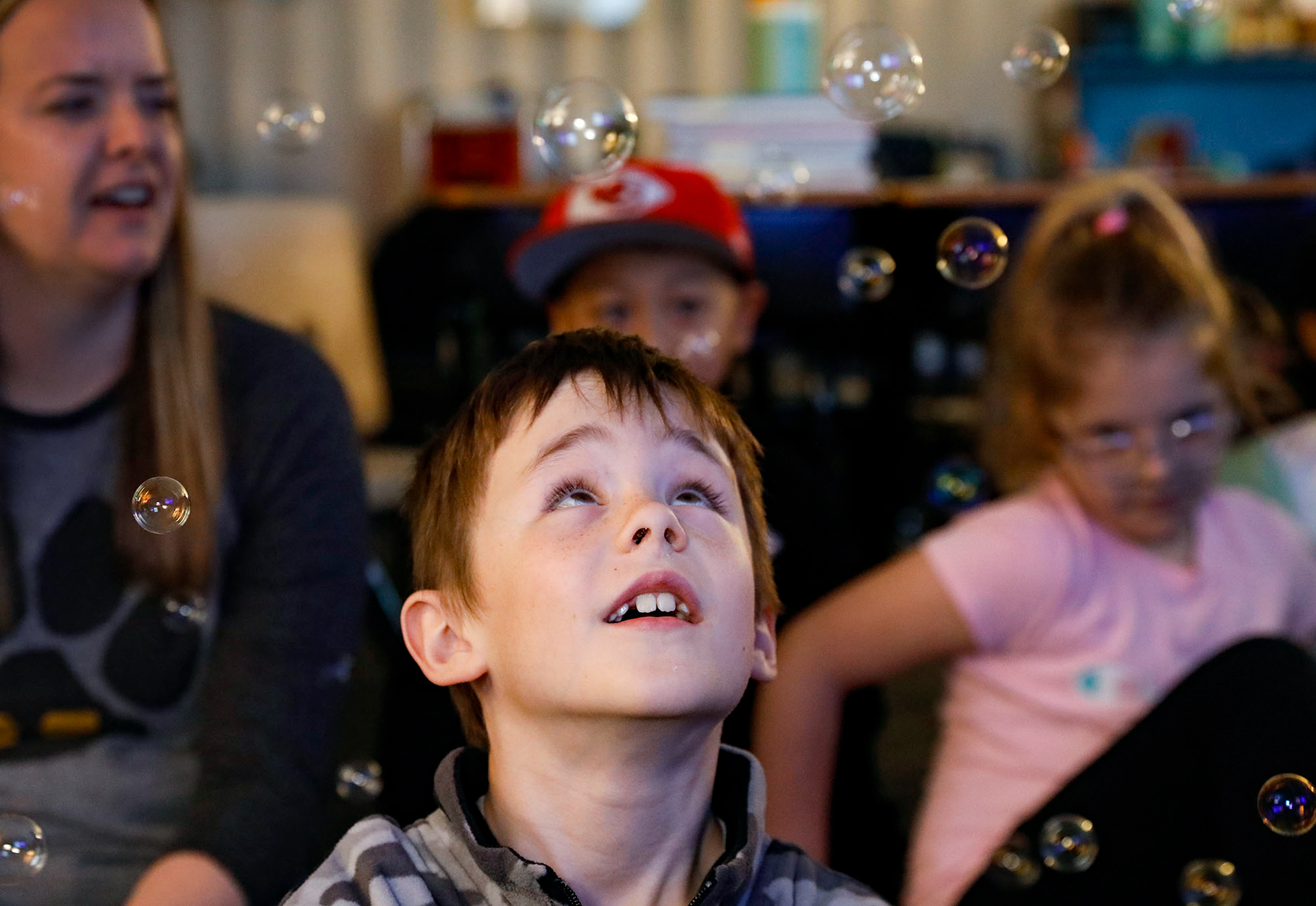 Second grader Weston Smith watches bubbles float above his head during a lesson on self control on March 14, 2024, at Cedar Creek Elementary.