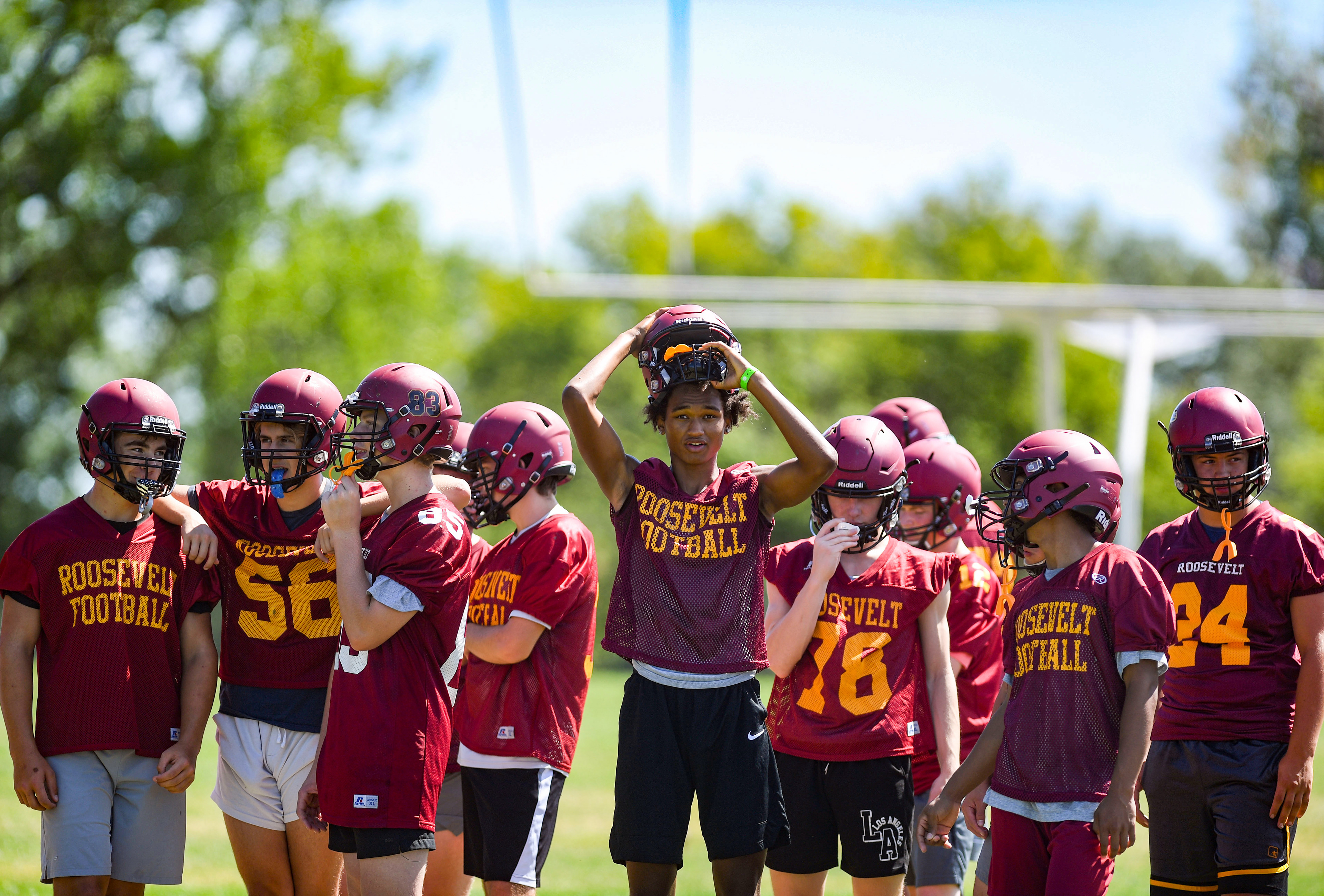Roosevelt players stand together between drills on the first day of football practice on Monday, August 8, 2022, in Sioux Falls.