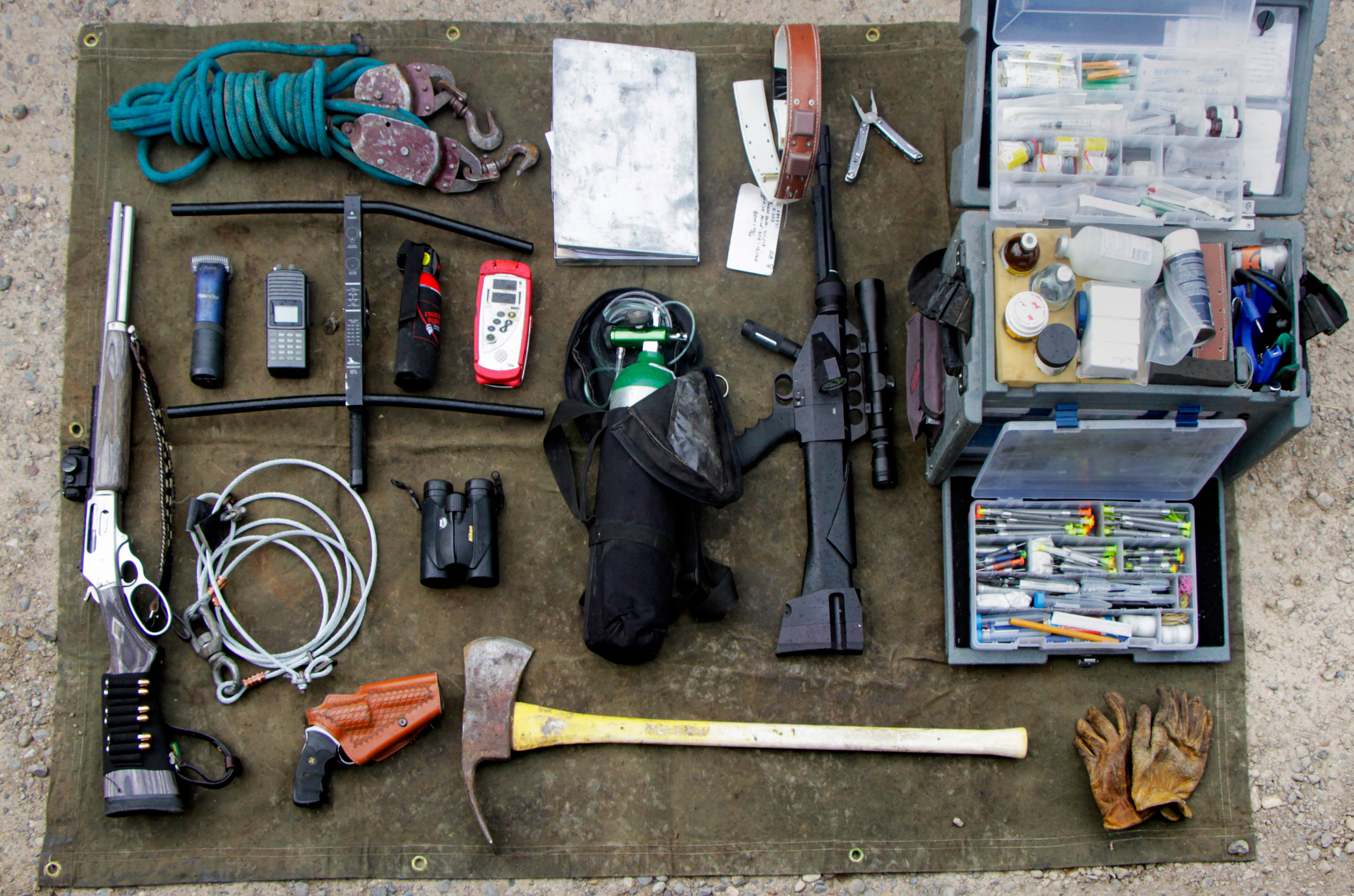Tools used by large carnivore biologists are laid out on a tarp at the research headquarters.