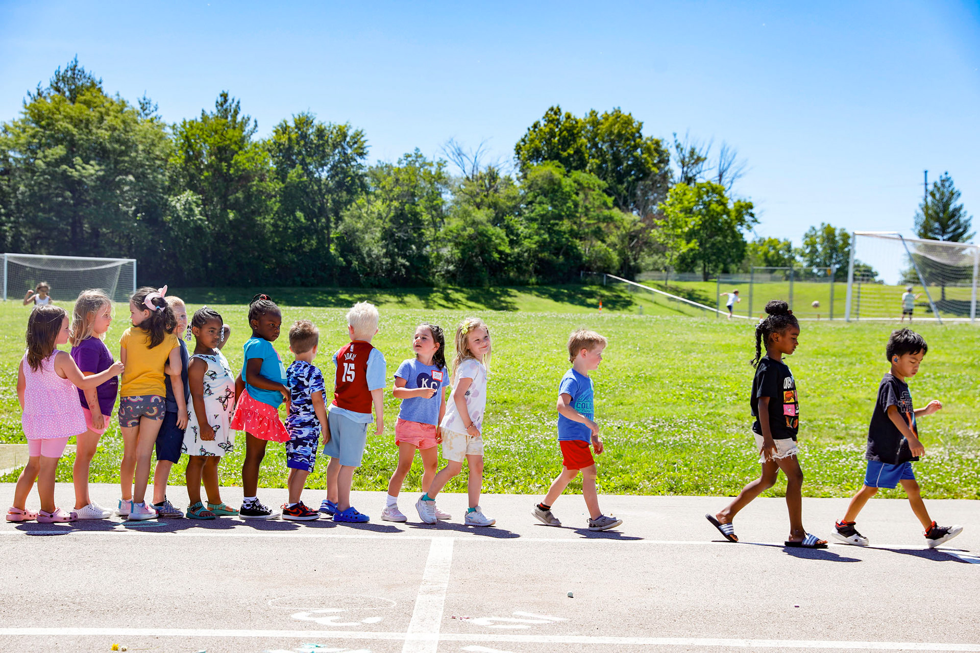 Students at Hawthorne Hill Elementary walk back into class after recess on June 10, 2024.