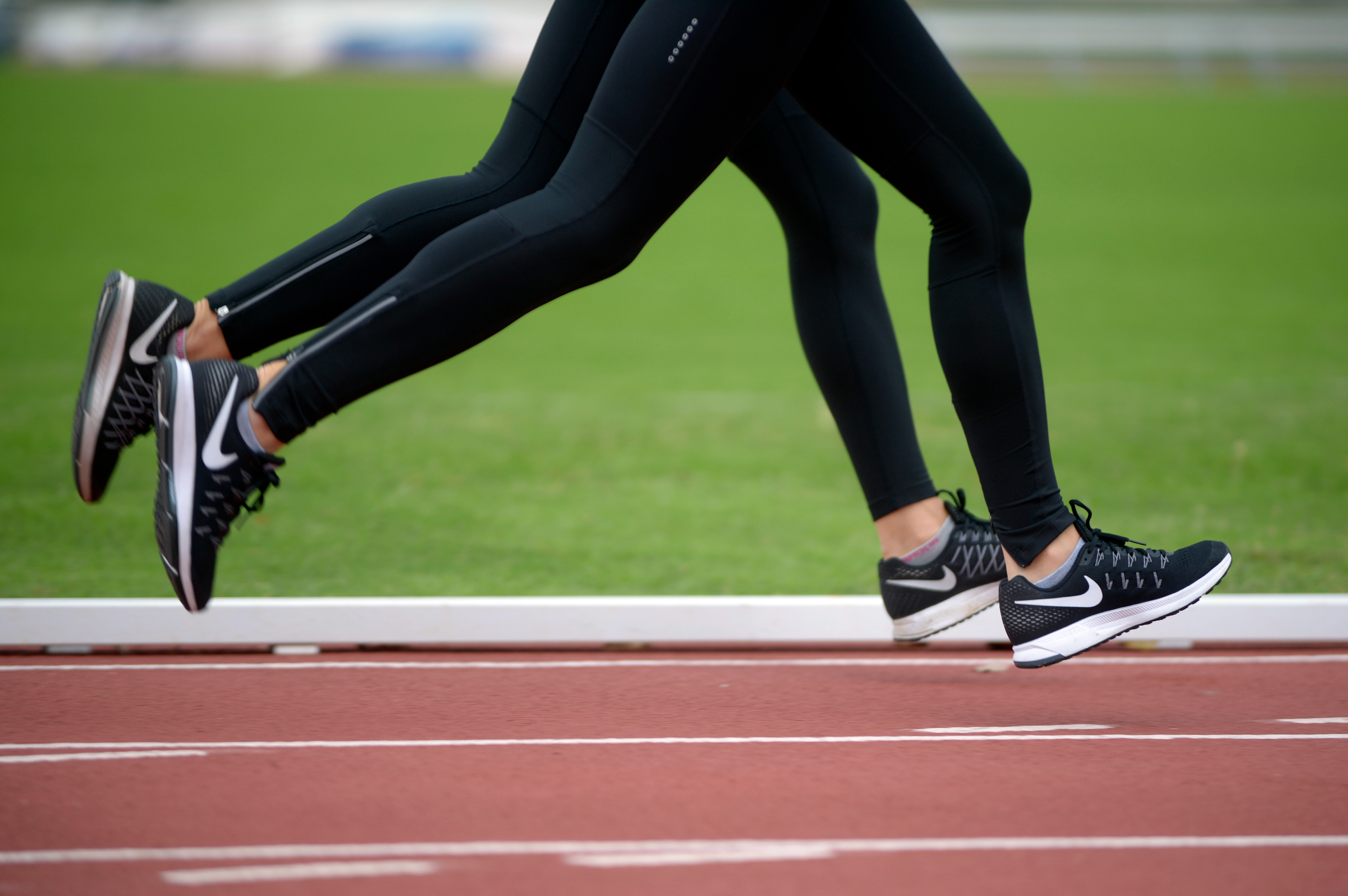 Bianca and Nicole Mello's steps fall in line as they run on the track at Walton Stadium on Wednesday, Oct. 19, 2016. The sisters often dress similarly at practice without realizing.