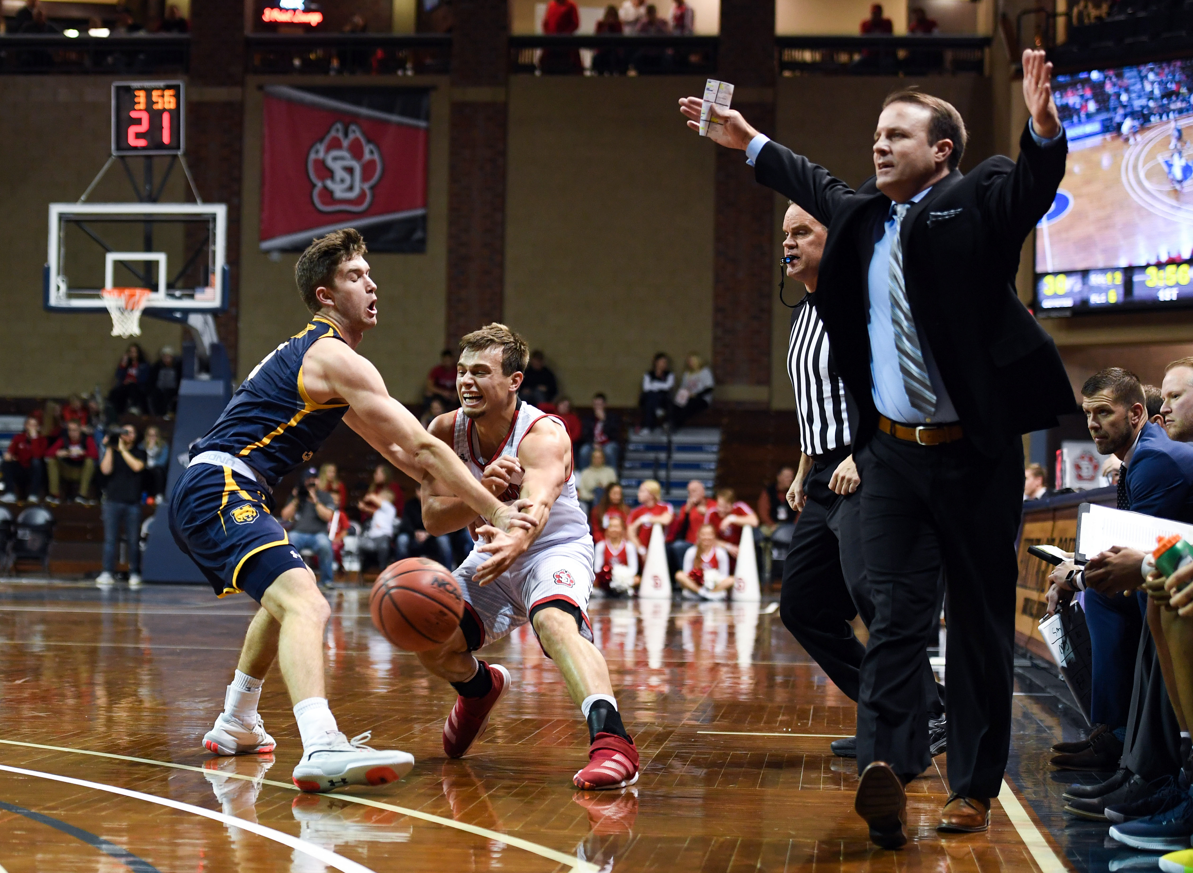 Sam Masten of Northern Colorado knocks the ball from USD player Cody Kelley's hand as Northern Colorado coach Jeff Linder reacts to a foul being called on Friday, Dec. 20, 2019, at the Pentagon in Sioux Falls, SD.