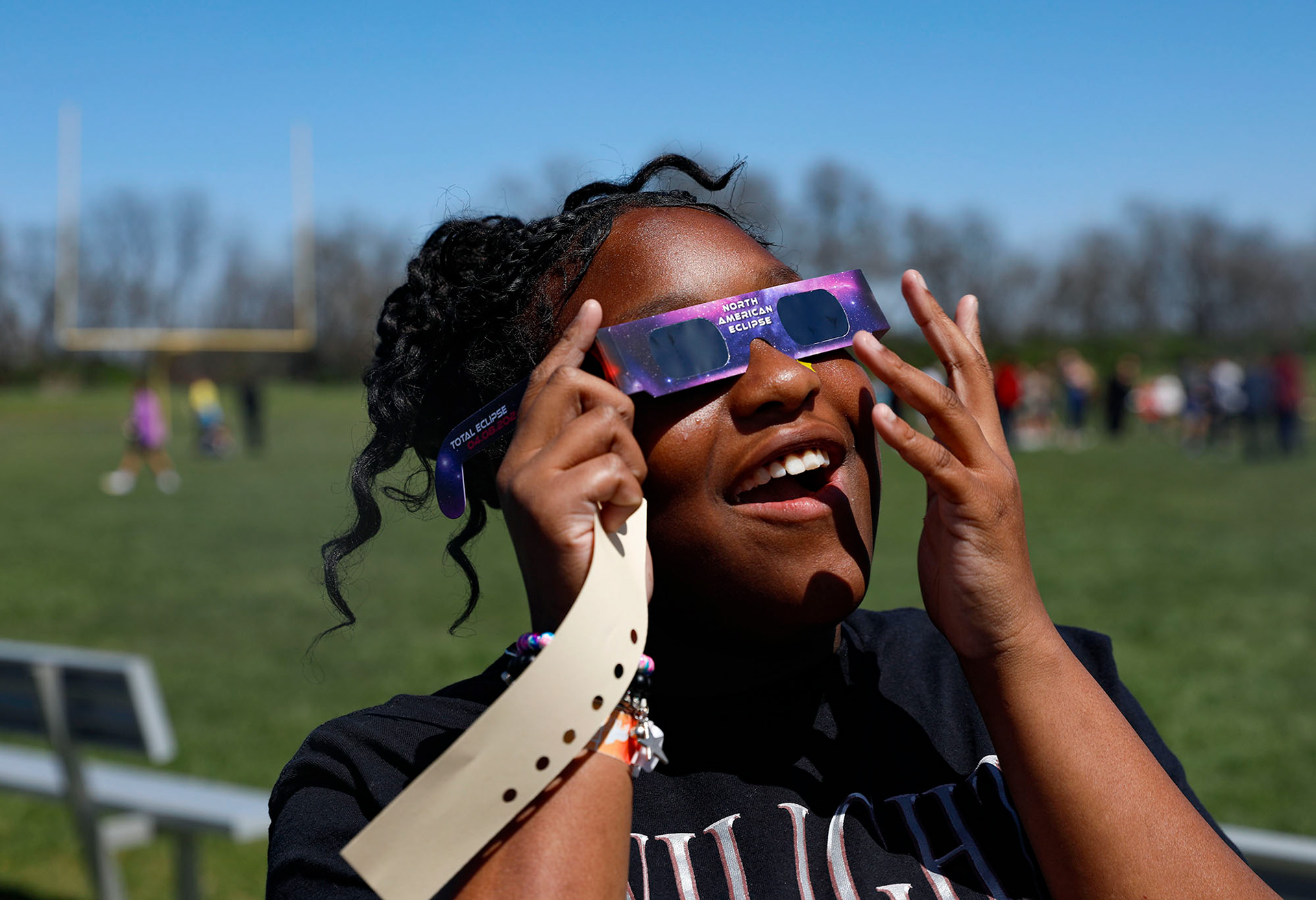 Seventh grader C'niyah Mack watches the solar eclipse with her class at Summit Lakes Middle School on April 8, 2024.