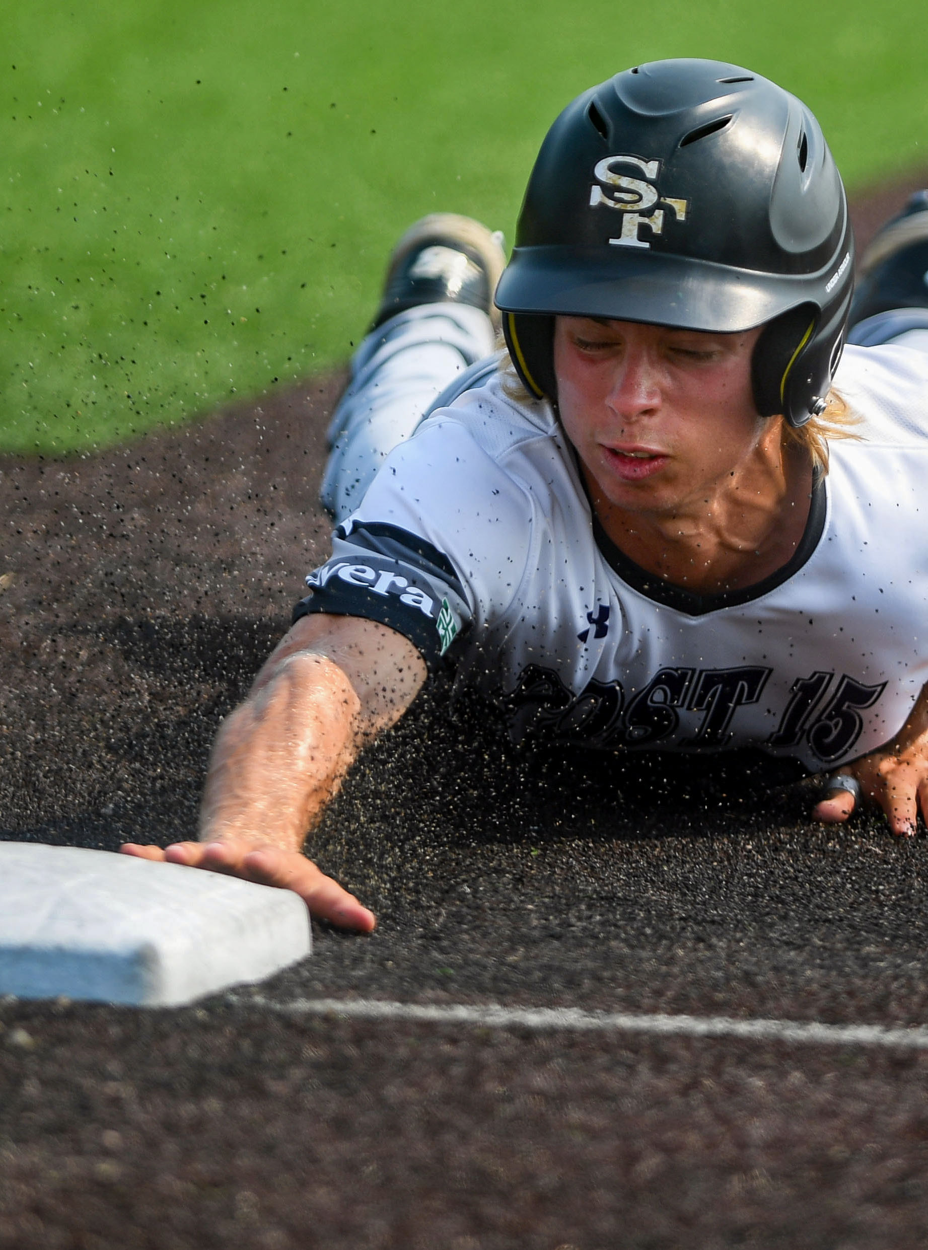 Sioux Falls East's Grant Graber slides back to first base in the American Legion state baseball championship on Tuesday, July 27, 2021, at Aspen Park in Brandon, SD.