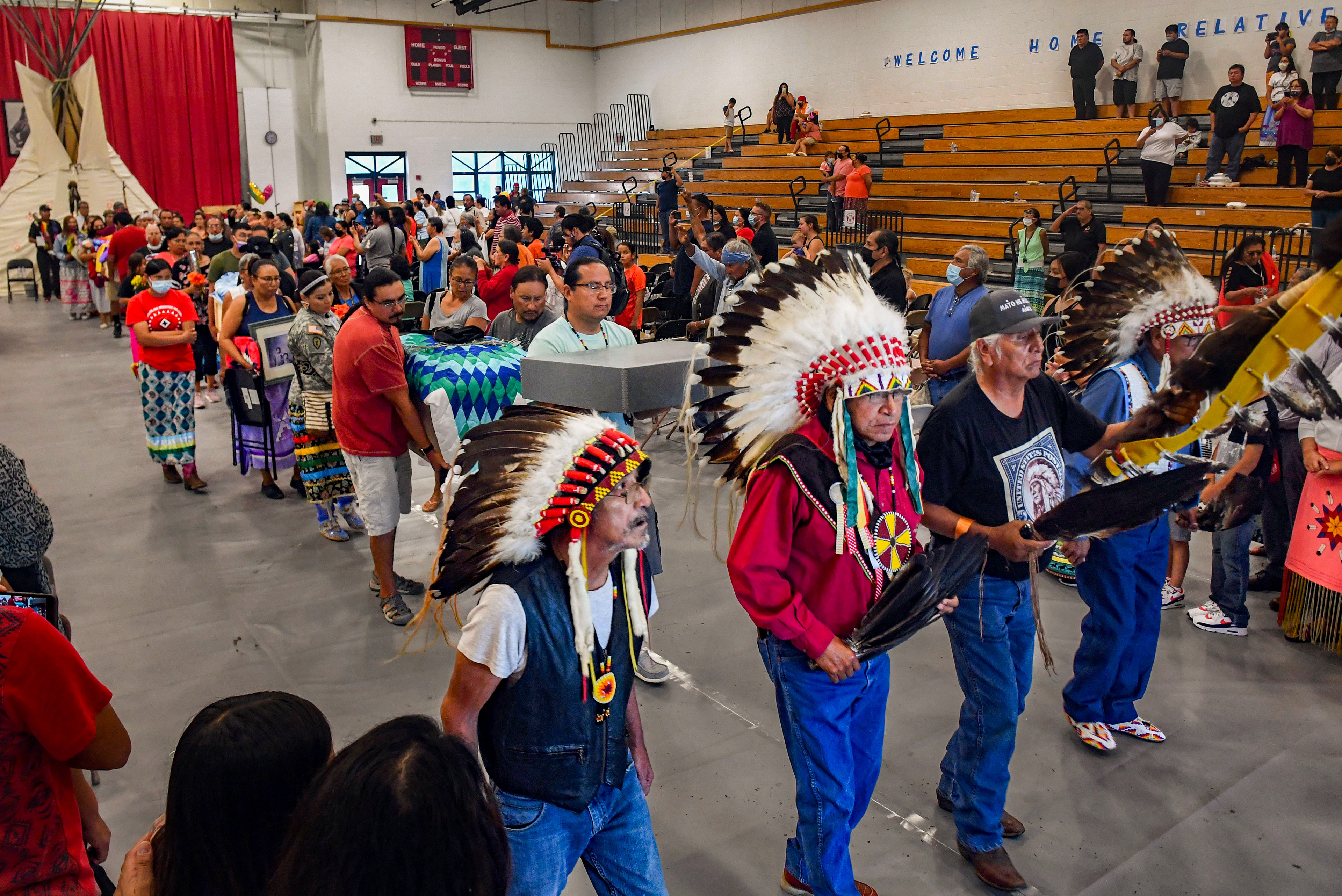Relatives of the nine children returned home for burial process out to their vehicles to journey to the cemeteries on Friday, July 17, 2021 at the Sinte Gleska University Student Multicultural Center.