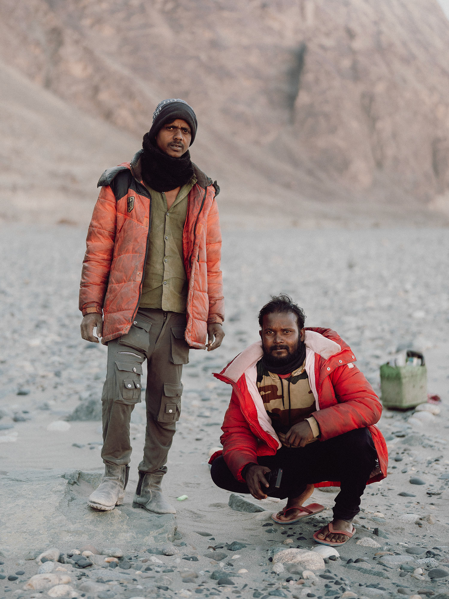 Two Bengali workers on a dried-out riverbed in close to Diskit in the northwesternmost valley of Indian administered territory between the Line of Control with Pakistan and the Line of Actual Control with China. They are daily labourers picking up stones from the riverbed and using them to make landslide barriers.