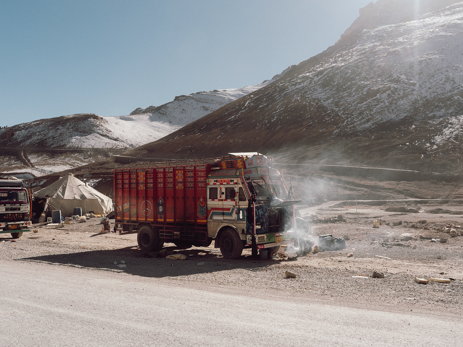 A pair of truckers cooking on NH3 between Leh and Manali. Most of the road is above 4000 meters of elevation and extremely challenging