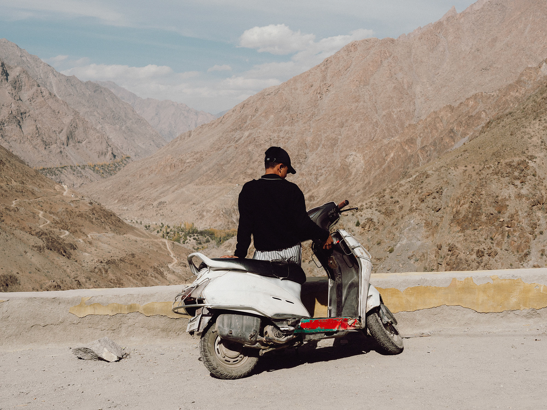 Just outside of Kargil, the LoC marks the border between indian-administered Ladakh and the Pakistani-administered Baltistan. Here, a boy drove his scooter up a mountain road overlooking the LoC. The road and mountains seen behind him are across the LoC. No one is allowed to cross the valley.