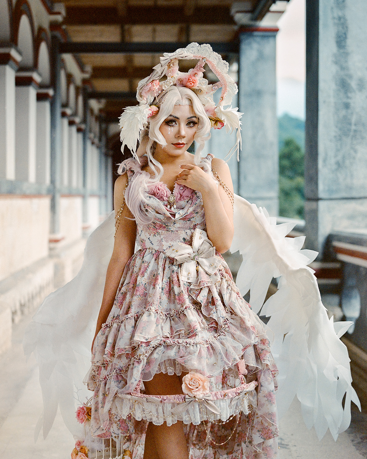 Lancy. Lancy is a student who has loved Lolita for six years. At first she liked Lolita because it looked pretty, then she gradually adopted it as her everyday dressing style. She is independent and has made many friends with the Lolita community. She loves the style and design of the dress on her and has created a make-up look to go with it. We made the photo at Seminarium Annuntiationis, which is built in 1895.