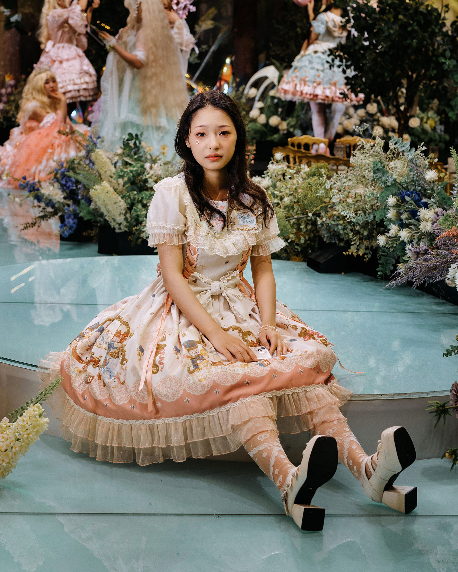 Xiao Nan. Xiao Nan is the organiser of the Lolita Tea Party in Chengdu and one of the leaders of the local Lolita community. 2023 was the end of China's strict epidemic prevention and control policy. She organised a huge tea party that attracted over 150 Lolita enthusiasts, even more than before the Covid-19 pandemic. After the tea party, she took off her wig and I took this photo of her looking a little tired.