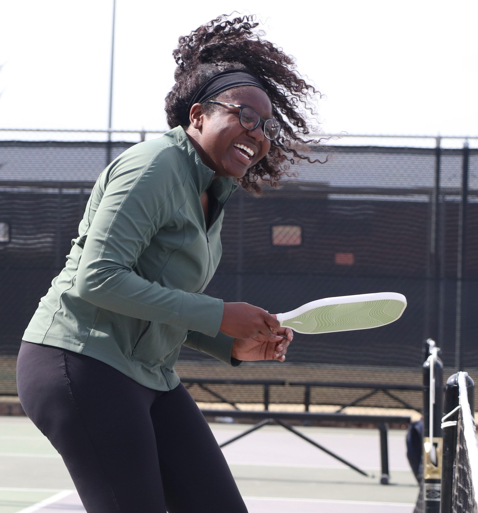 Amarachi Ekeke smiles after spiking the ball to win a point during a pickleball game, Thursday, Feb. 12, 2026, at the Urbanovsky Park pickleball courts in Lubbock, Texas. Ekeke participated in a Texas Tech University pickleball class at the park.