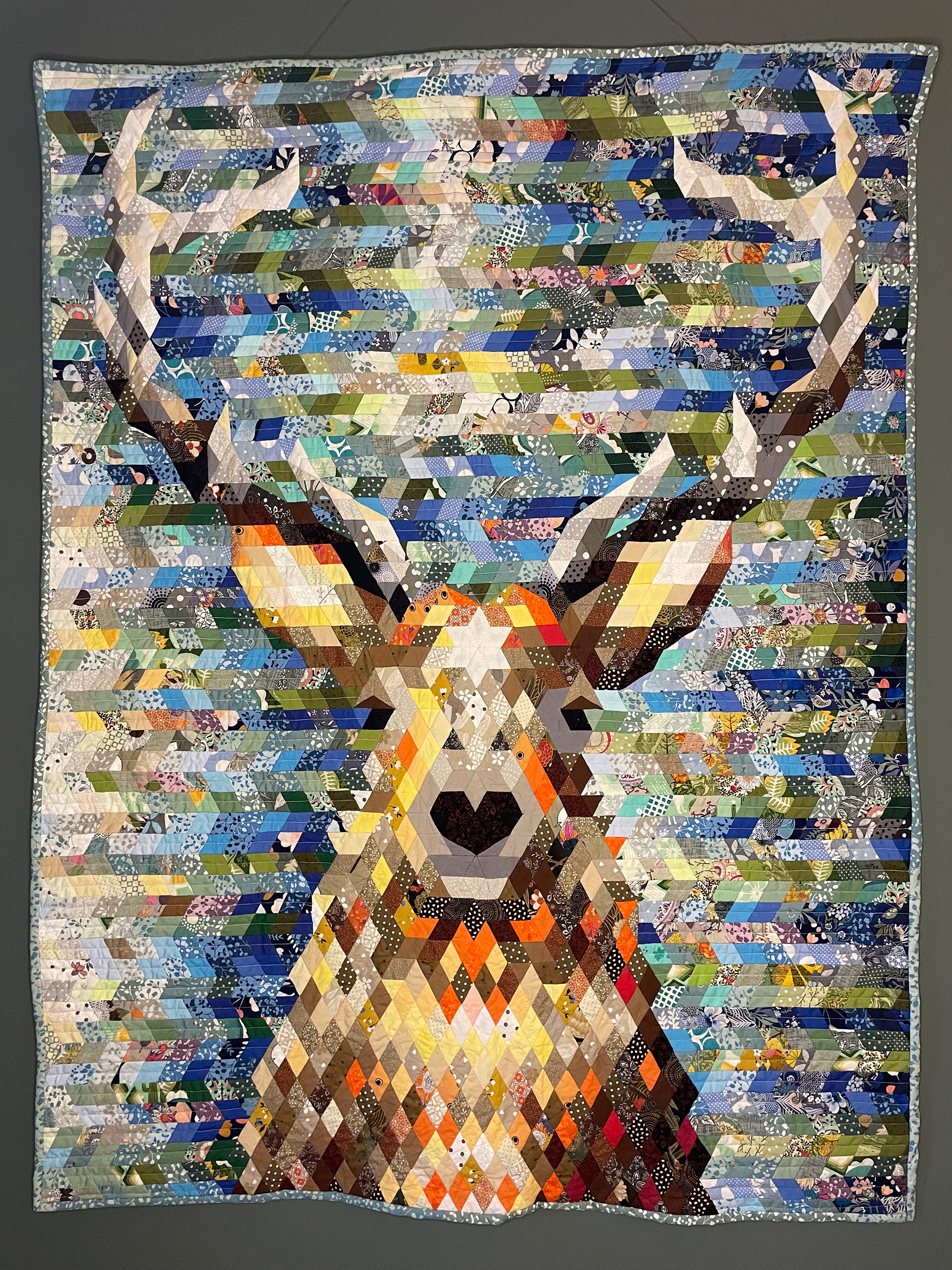 Patchwork EPP wall hanging of a stag head. Downloadable pattern.