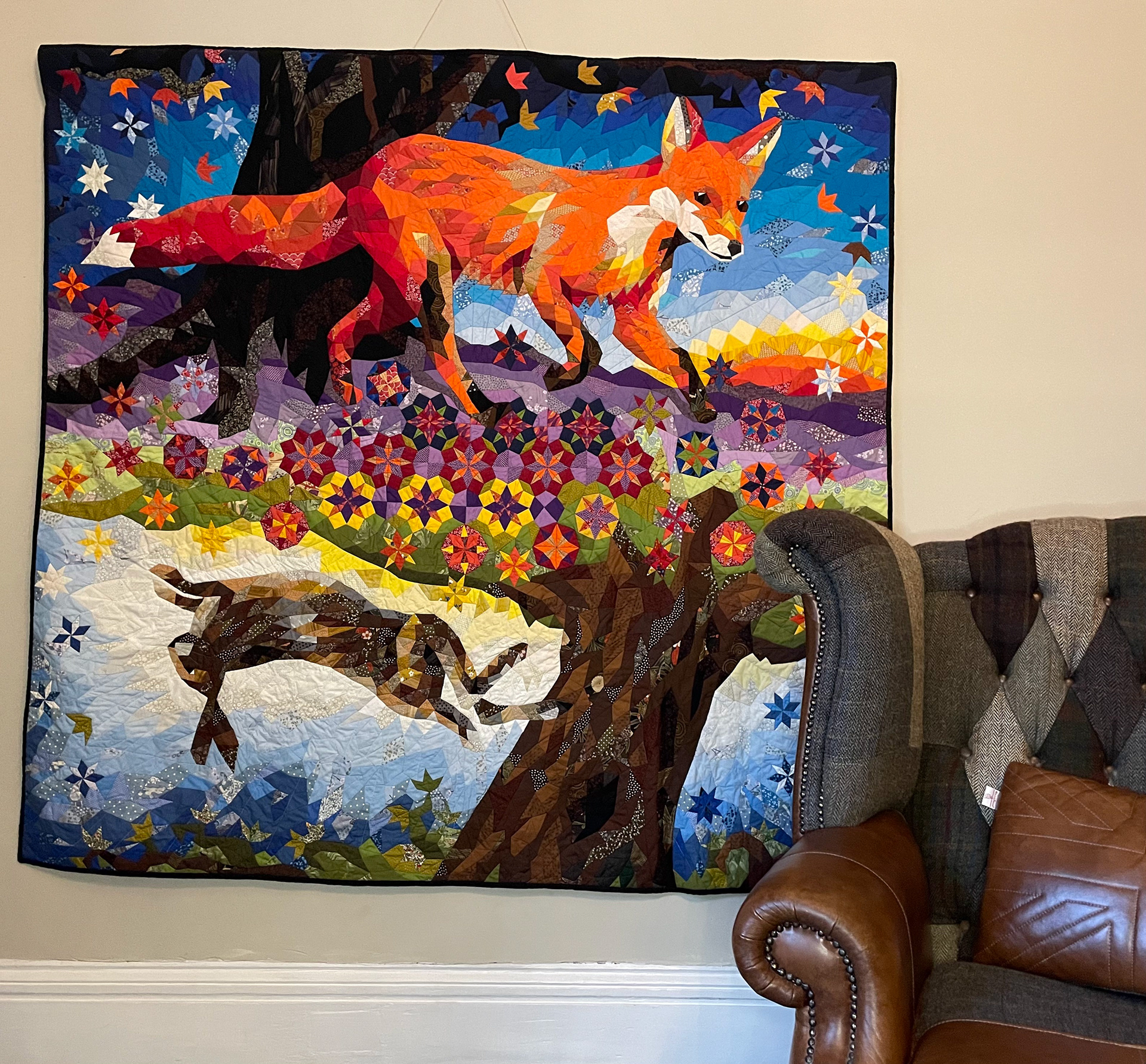 epic patchwork wall hanging with fox and hare in a forest scene, made in an irregular epp downloadable pattern