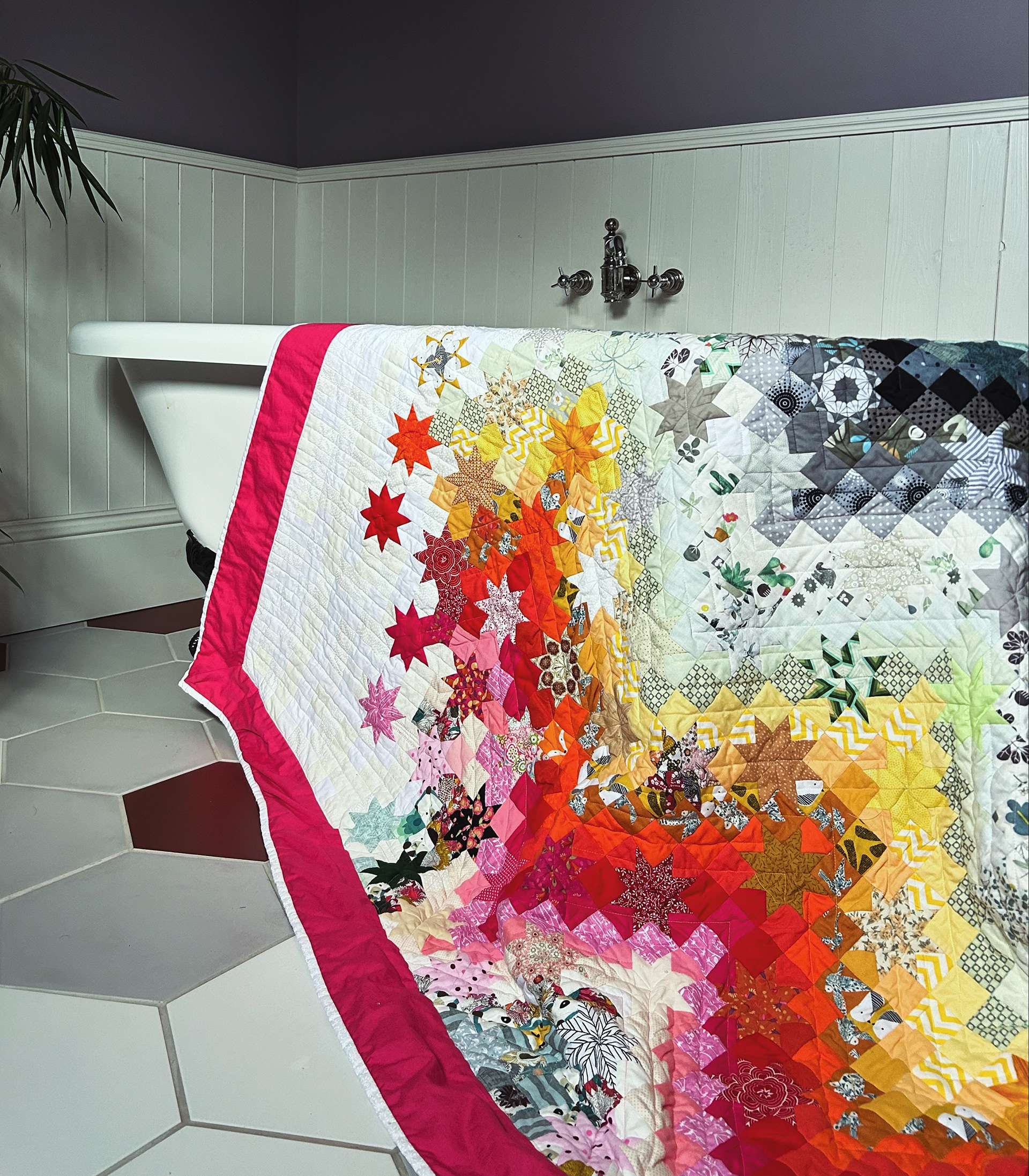 Colourful modern bed quilt with bold zig zag design with stars