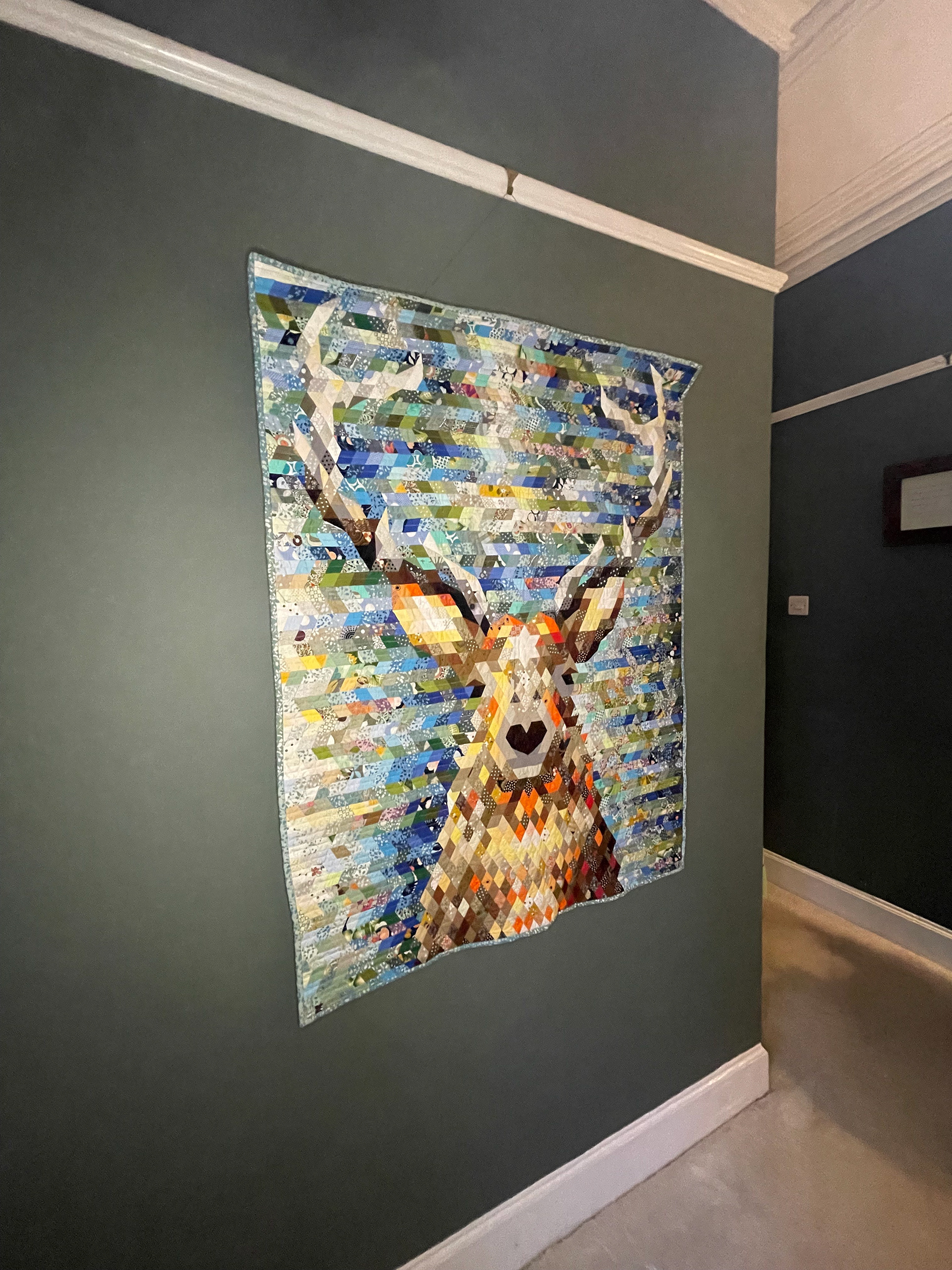 Patchwork epp wall hanging of a stag head. 