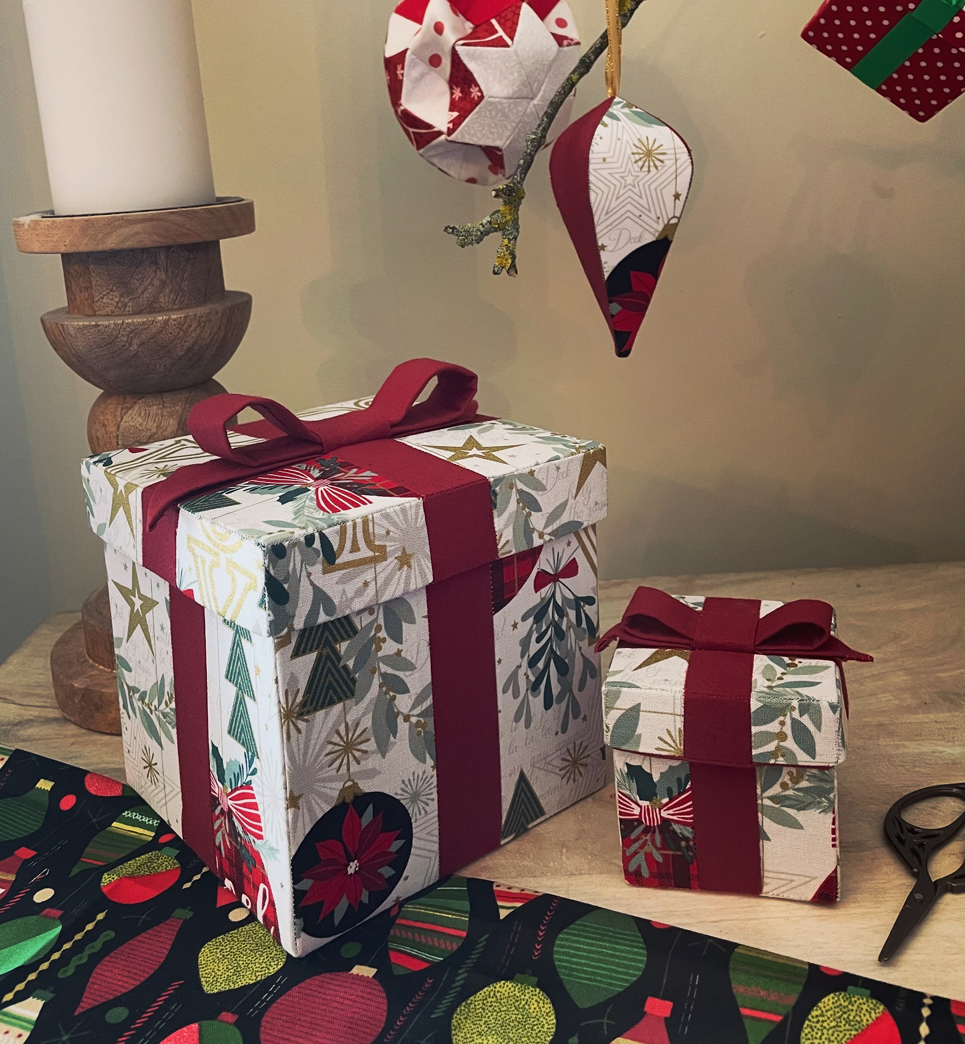 handmade Christmas gift boxes made in a patchwork style from a downloadable pattern.